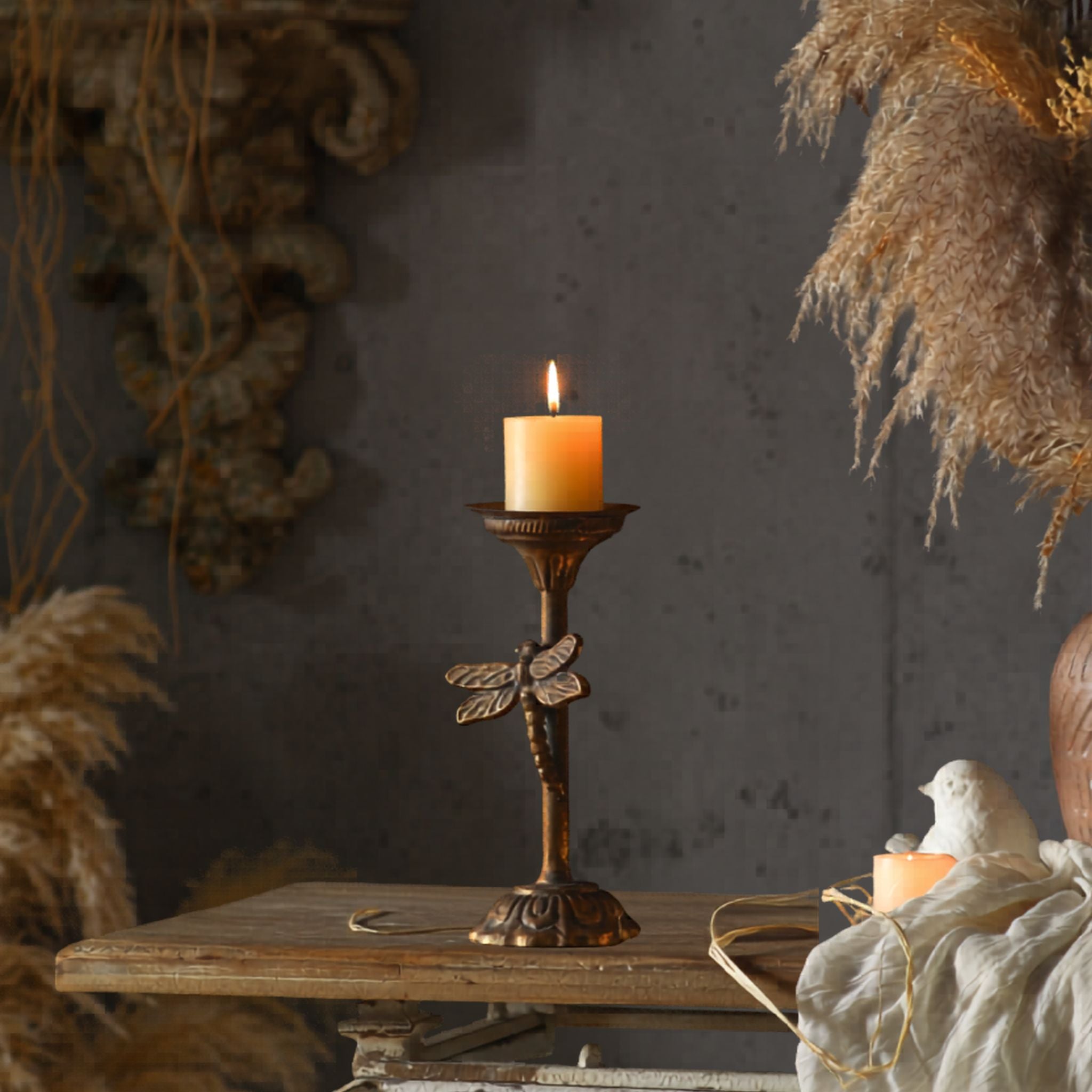 Lara dragonfly candlestick showing the moulded dragonfly on the slim stem above a lotus foot