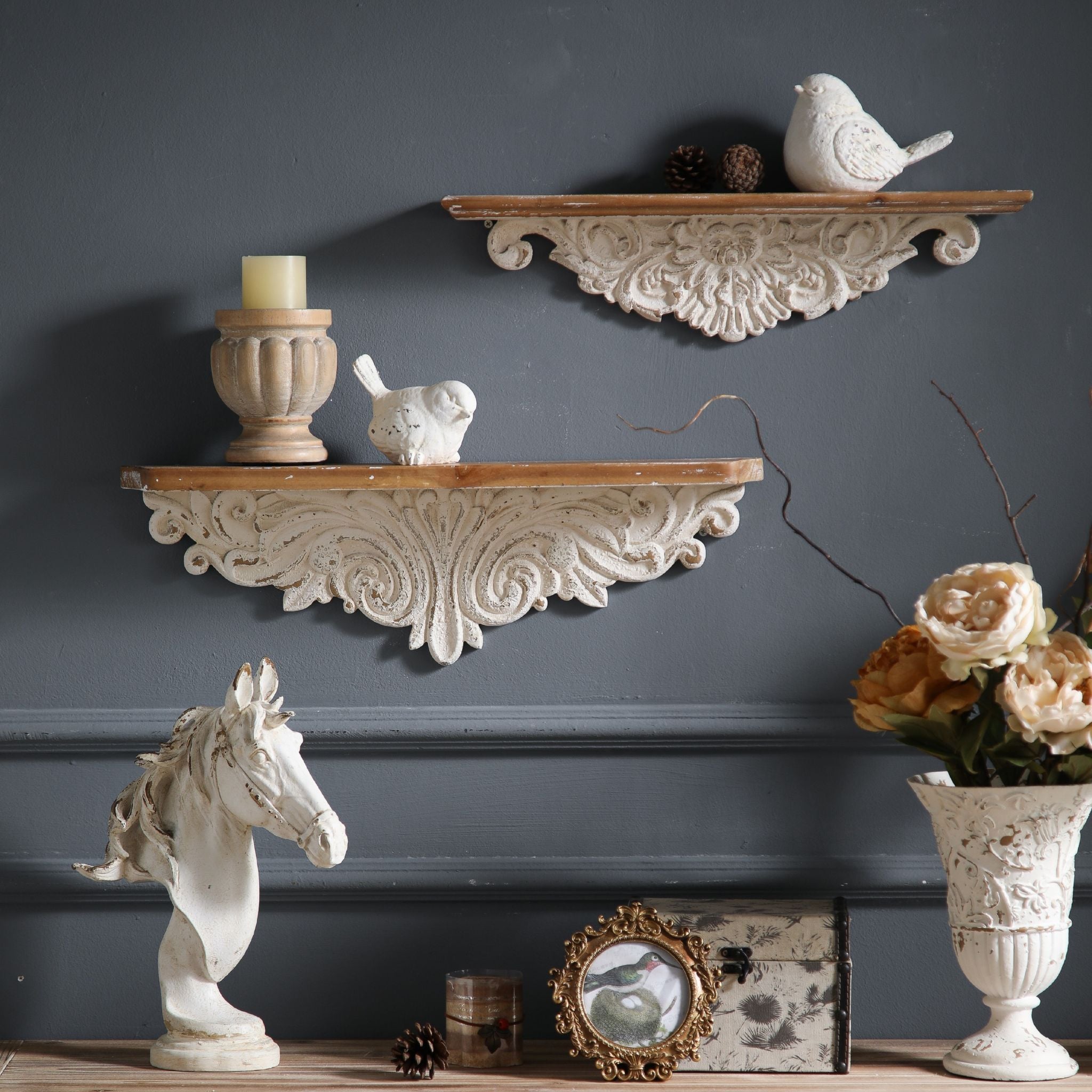 Jennifer wall ledge shelf shown upper position alongside Vanessa wider mantel ledge on lower position, demonstrating staggered wall pair styling above a console