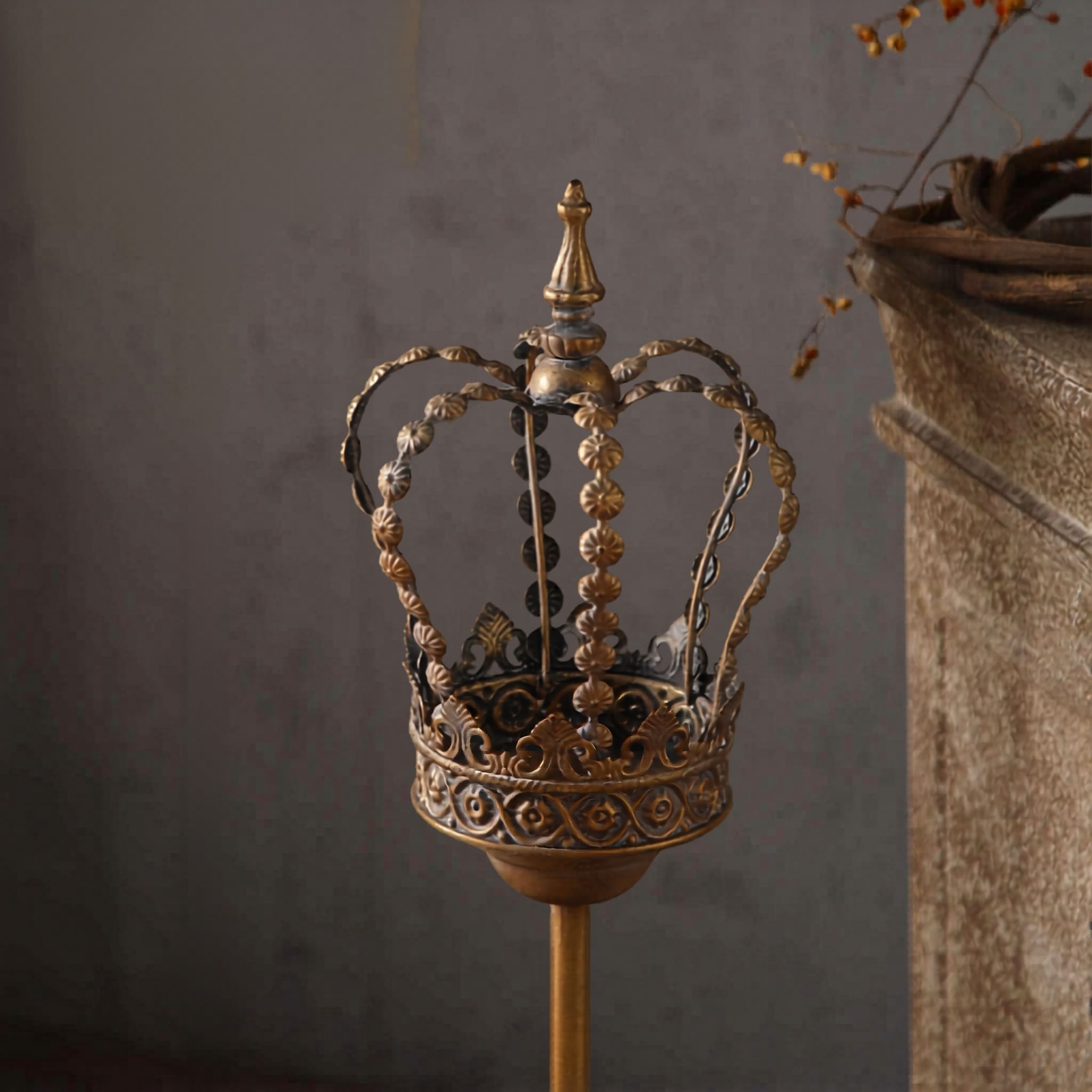 Close-up of openwork antique gold crown with beaded detail and finial