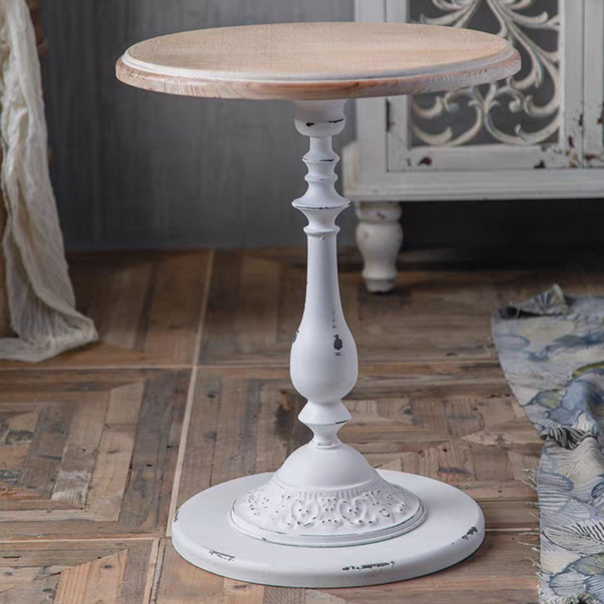 Juliette side table front view showing the turned white pedestal and moulded relief base