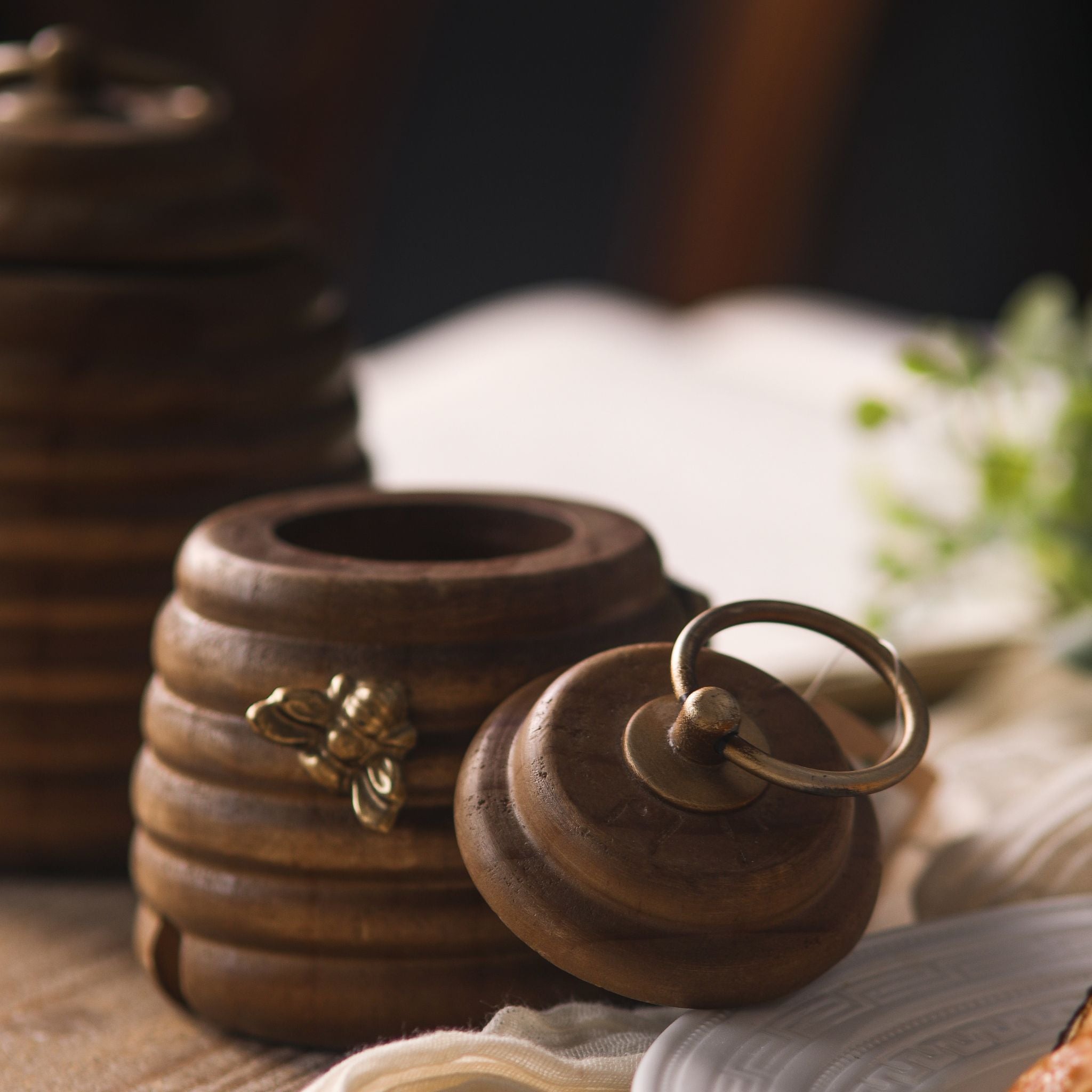 Laure larger pine beehive pot with the lid lifted off, showing the hollow inside and the brass ring on the lid.
