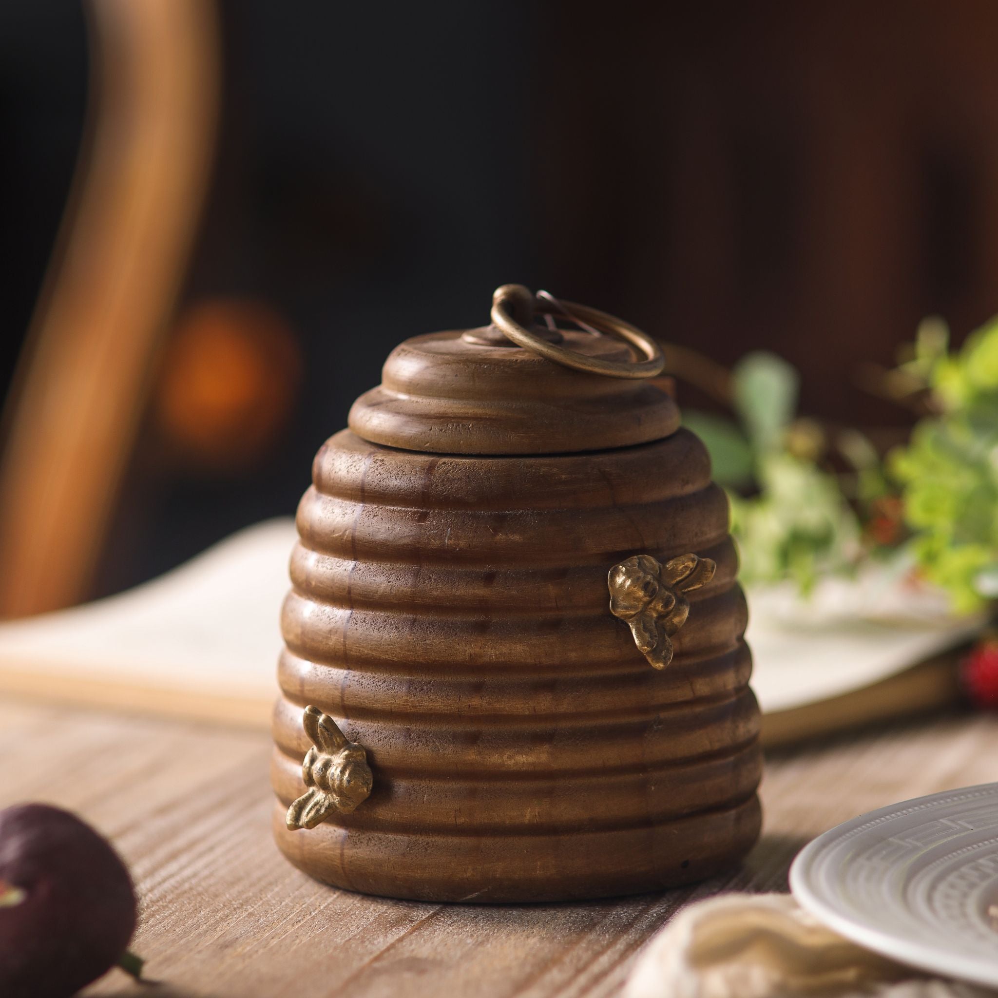 Laure single pine beehive honey pot with brass bees on the body and a brass ring-pull on the lid.