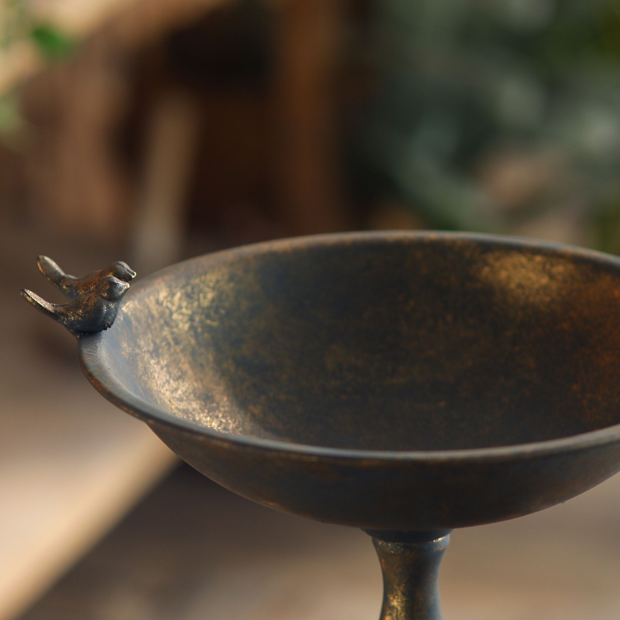 Close-up of the small perched bird ornament on the rim of the Lorraine dish stand.