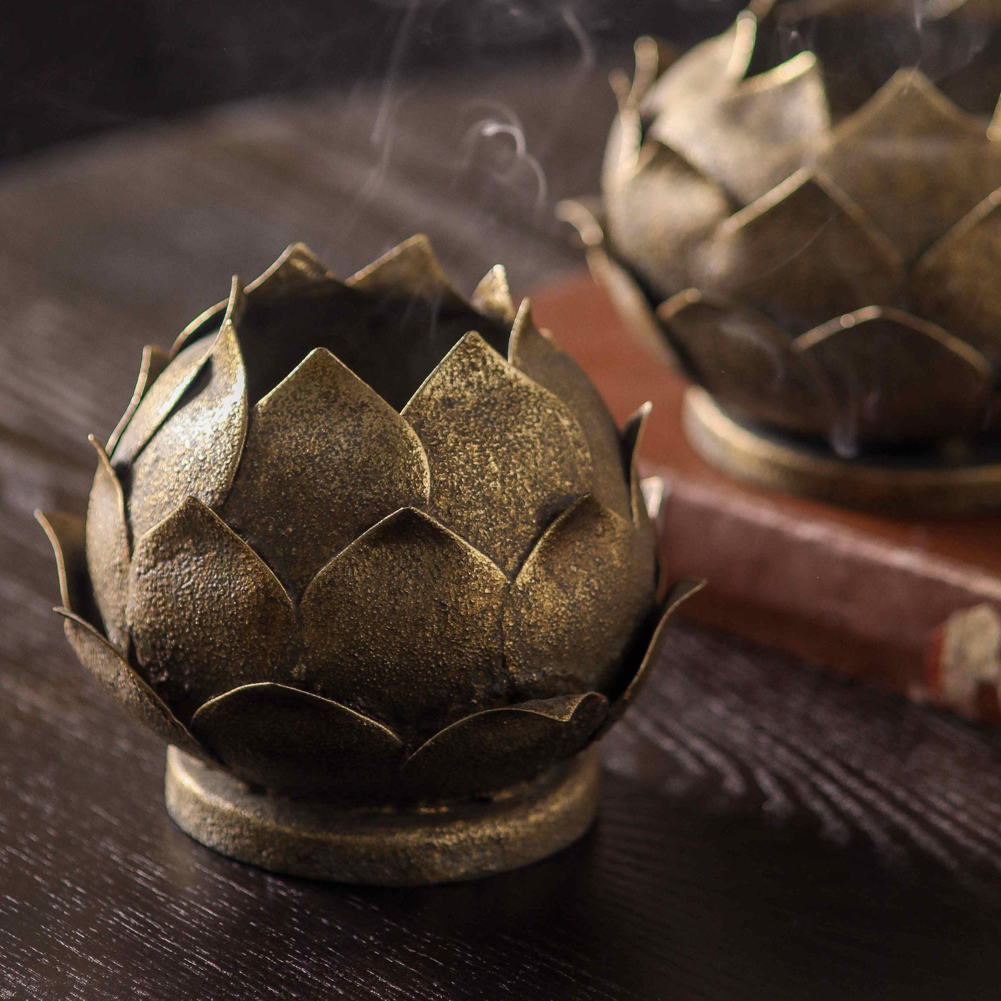 Close-up of the layered lotus petals in aged metal with an antique gold worn finish.