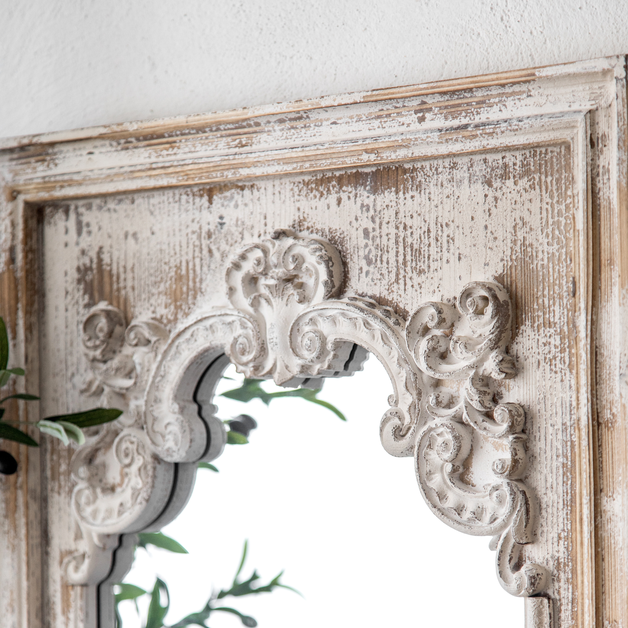 Distressed whitewashed timber frame and scrollwork corner detail of the Lucien mirror