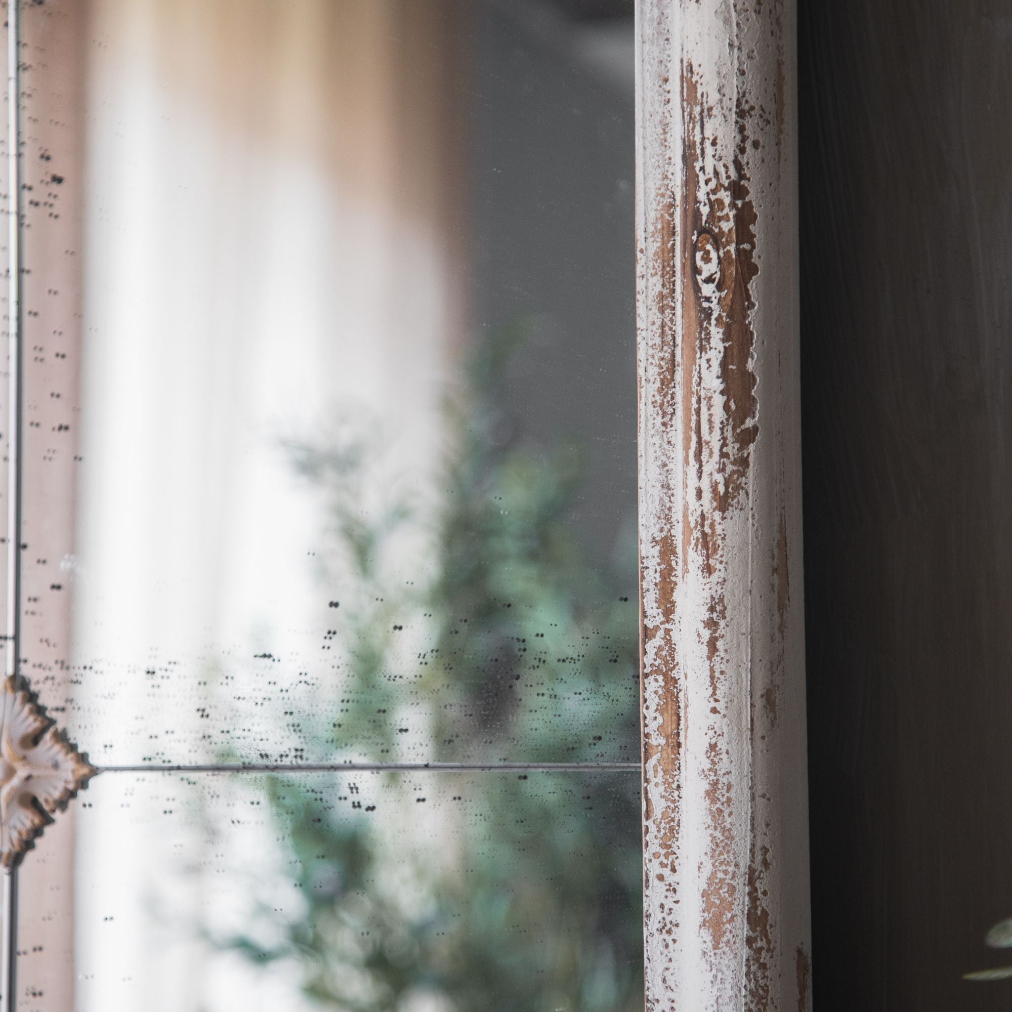 Side detail of the Marion mirror frame showing distressed white paint worn back to natural timber