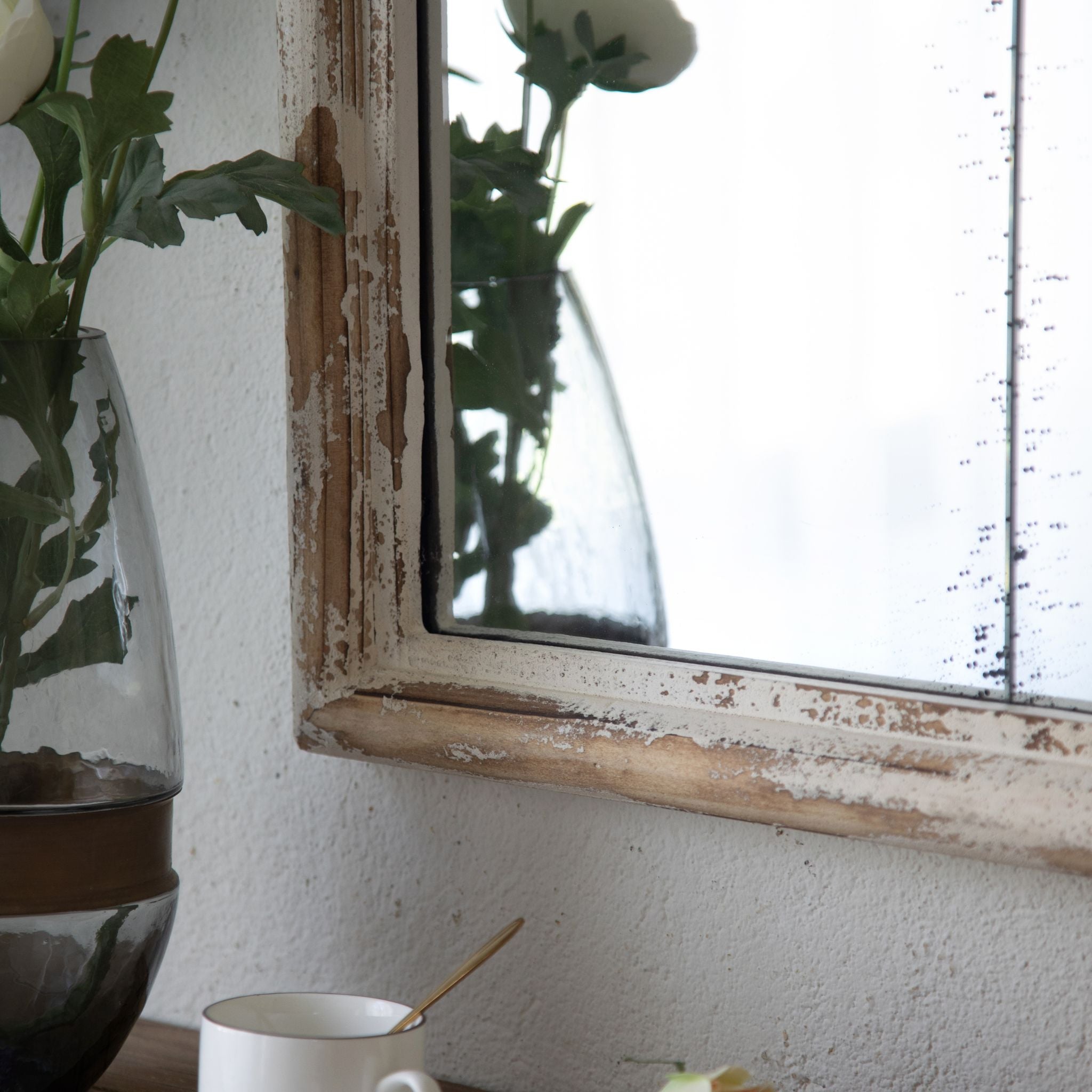 Marion arched mirror styled above a console with white roses in a glass vase