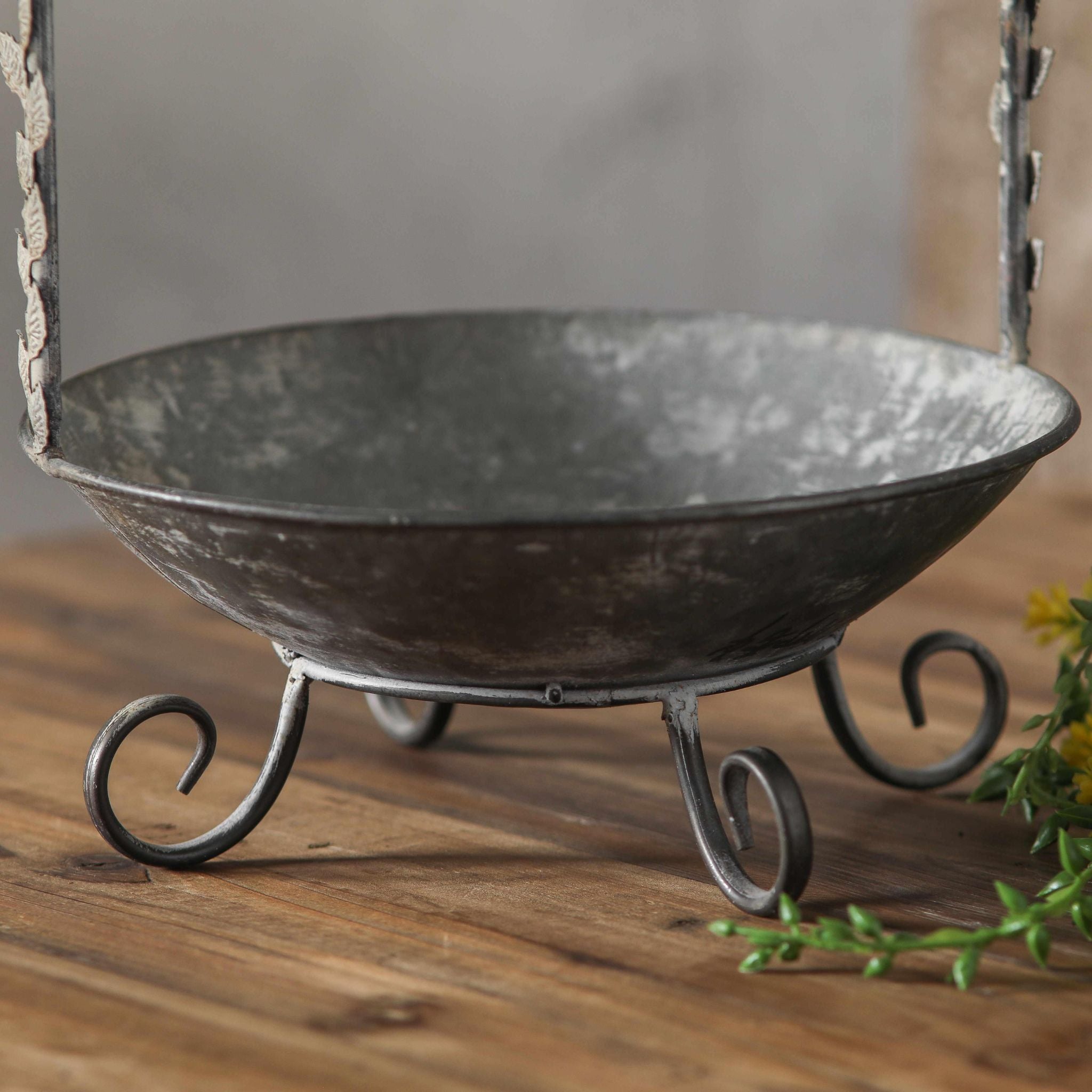 Close-up of the Meline basket bowl and scrolled feet in distressed zinc.