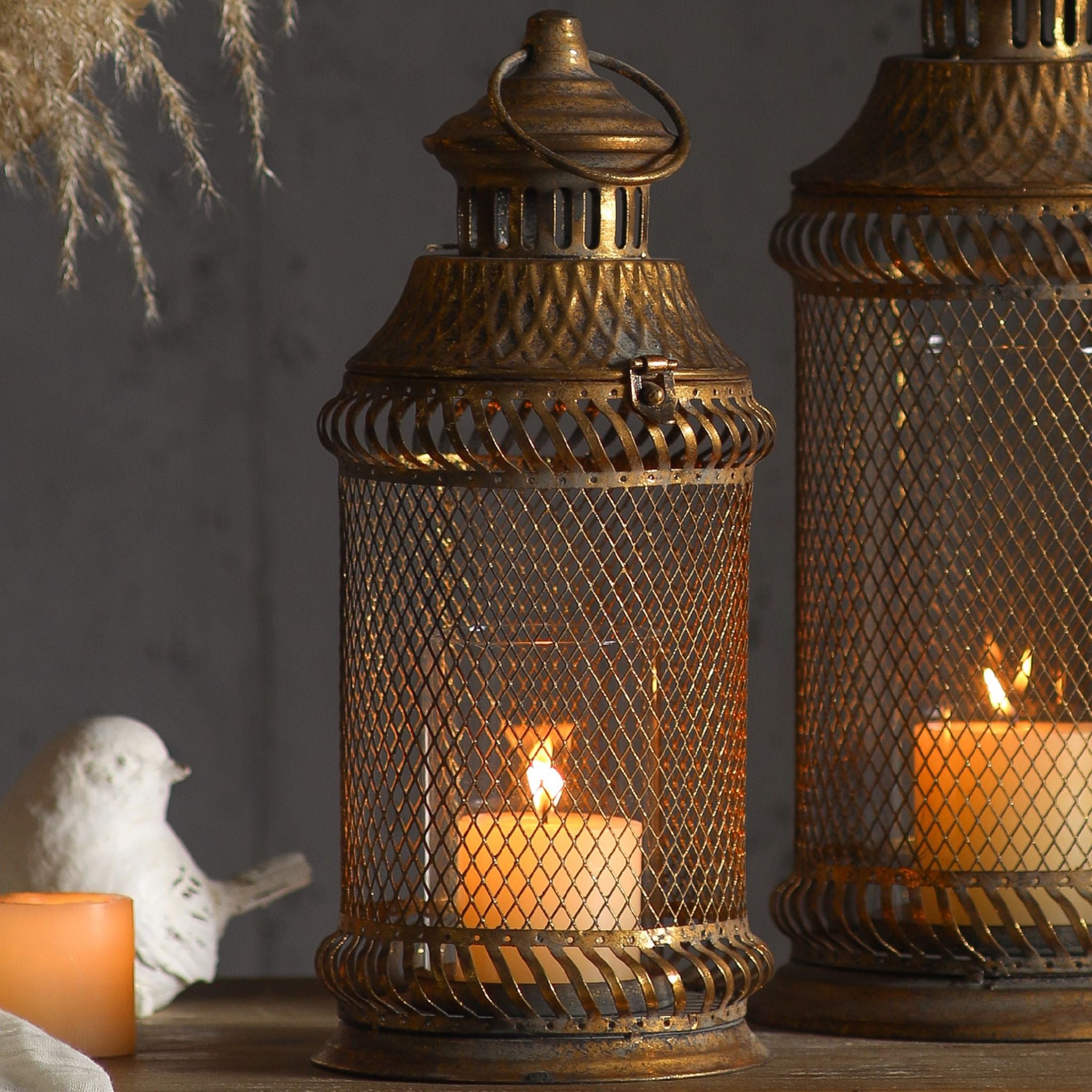 Mesh lantern lit, showing the candle behind the fine diamond lattice