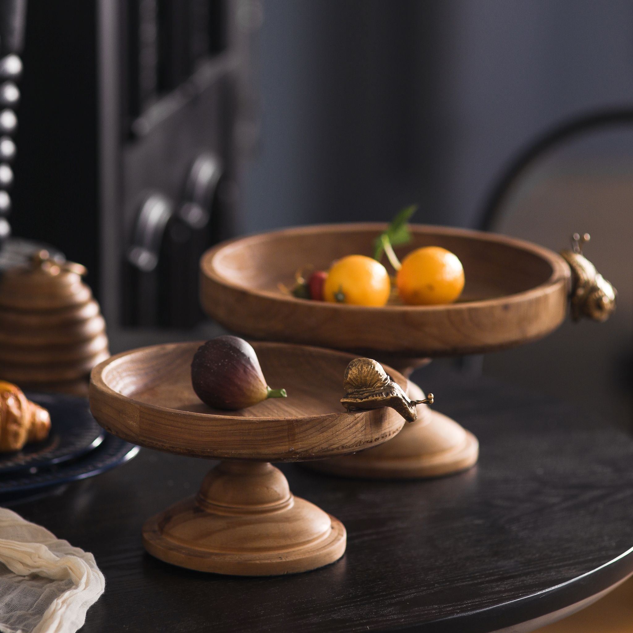 Two footed wooden trays in graduated sizes shown together, Ninette the larger.