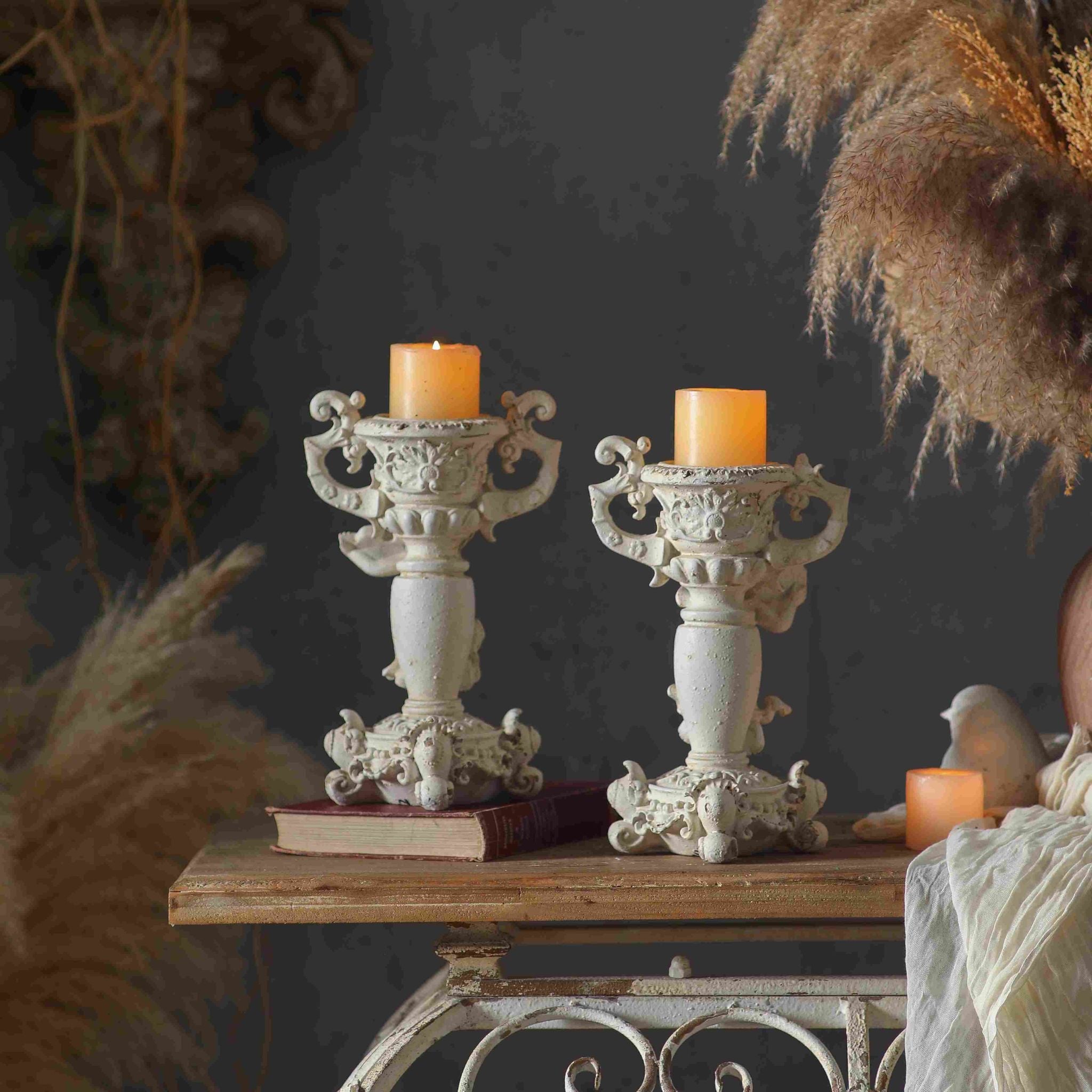 Jean Paul and Claude cherub candle holders styled together with pillar candles, each sold separately