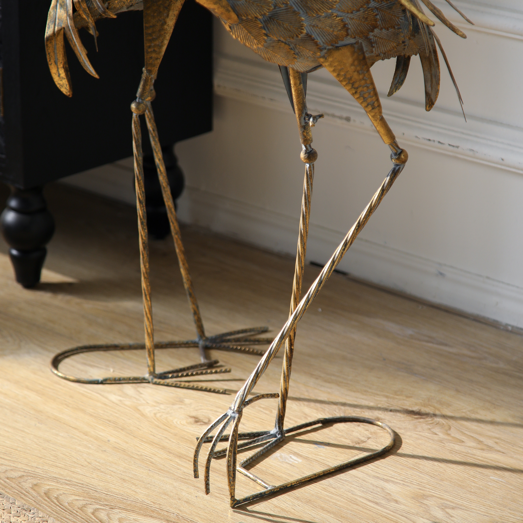 Detail of twisted iron legs and oval bases on Plumier flamingo sculptures
