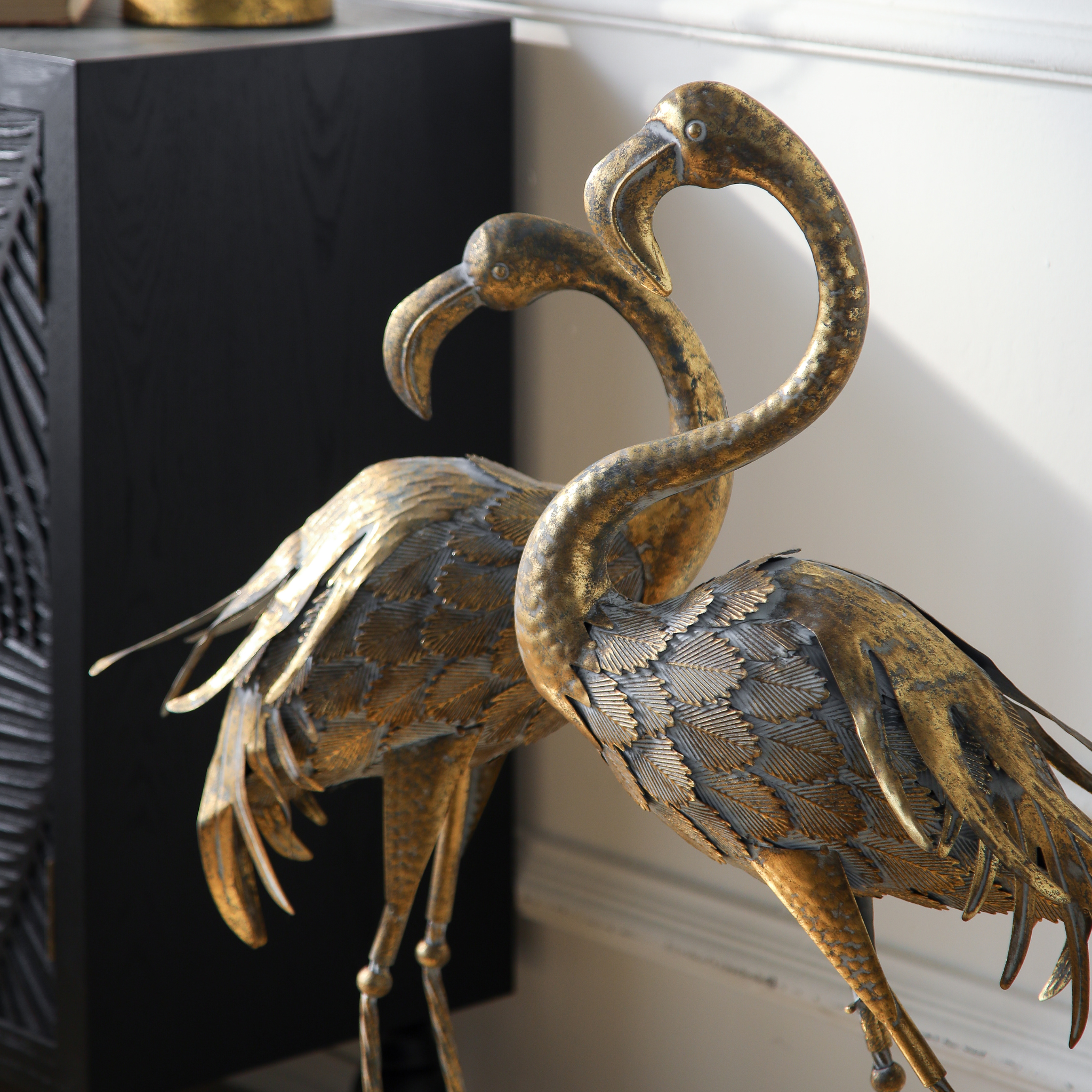 Detail of twisted iron legs and oval bases on Plumier flamingo sculptures