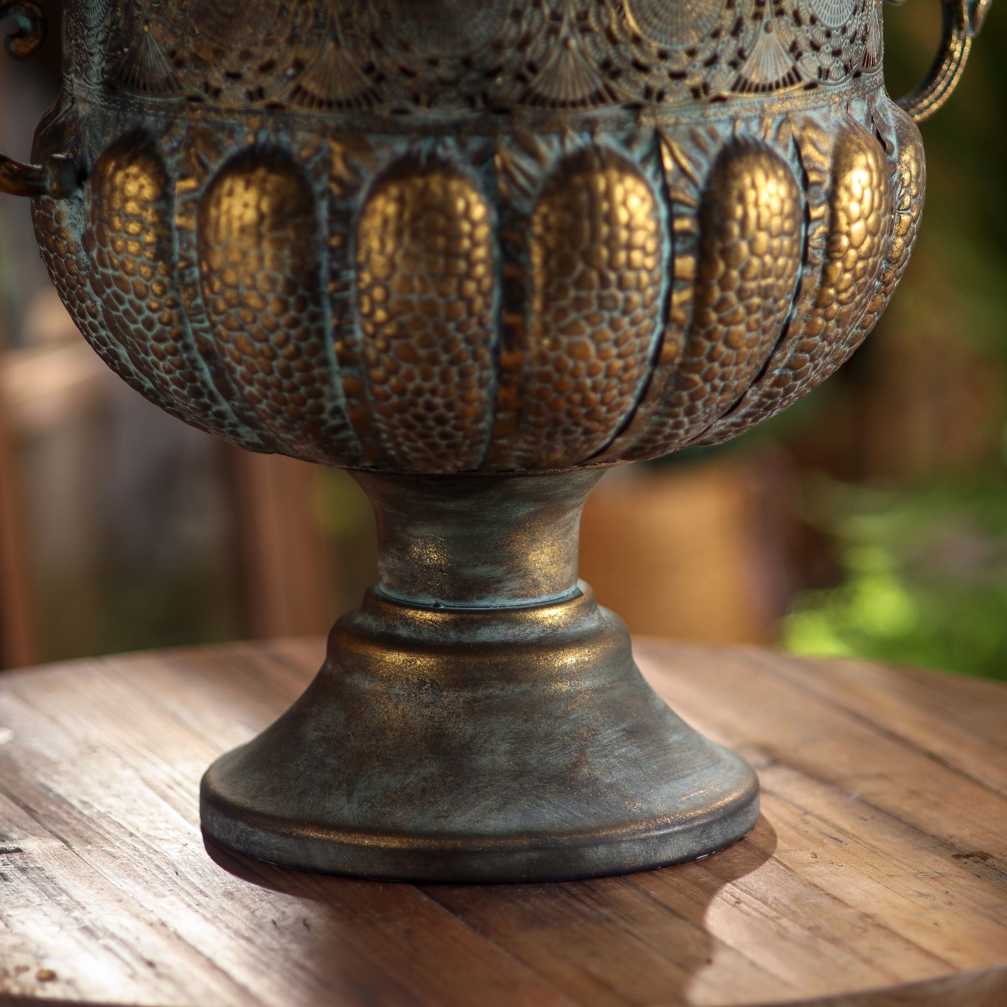 Regis urn planter close-up of the embossed lower bowl and pedestal foot
