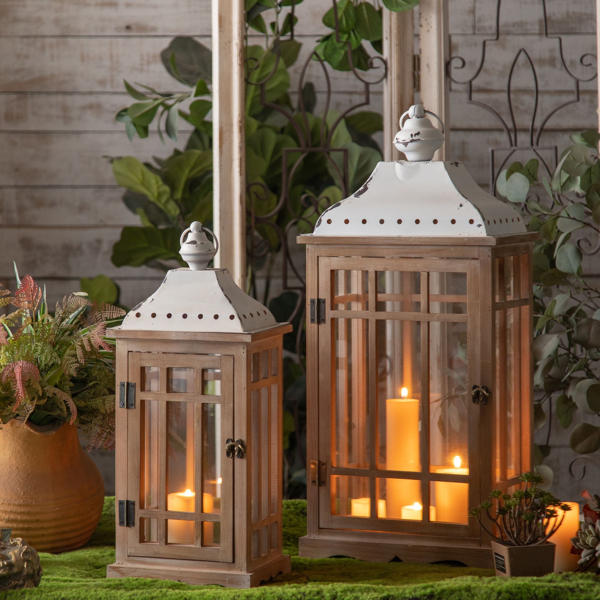 Richard set of two fir timber and glass lanterns with white metal roofs, lit