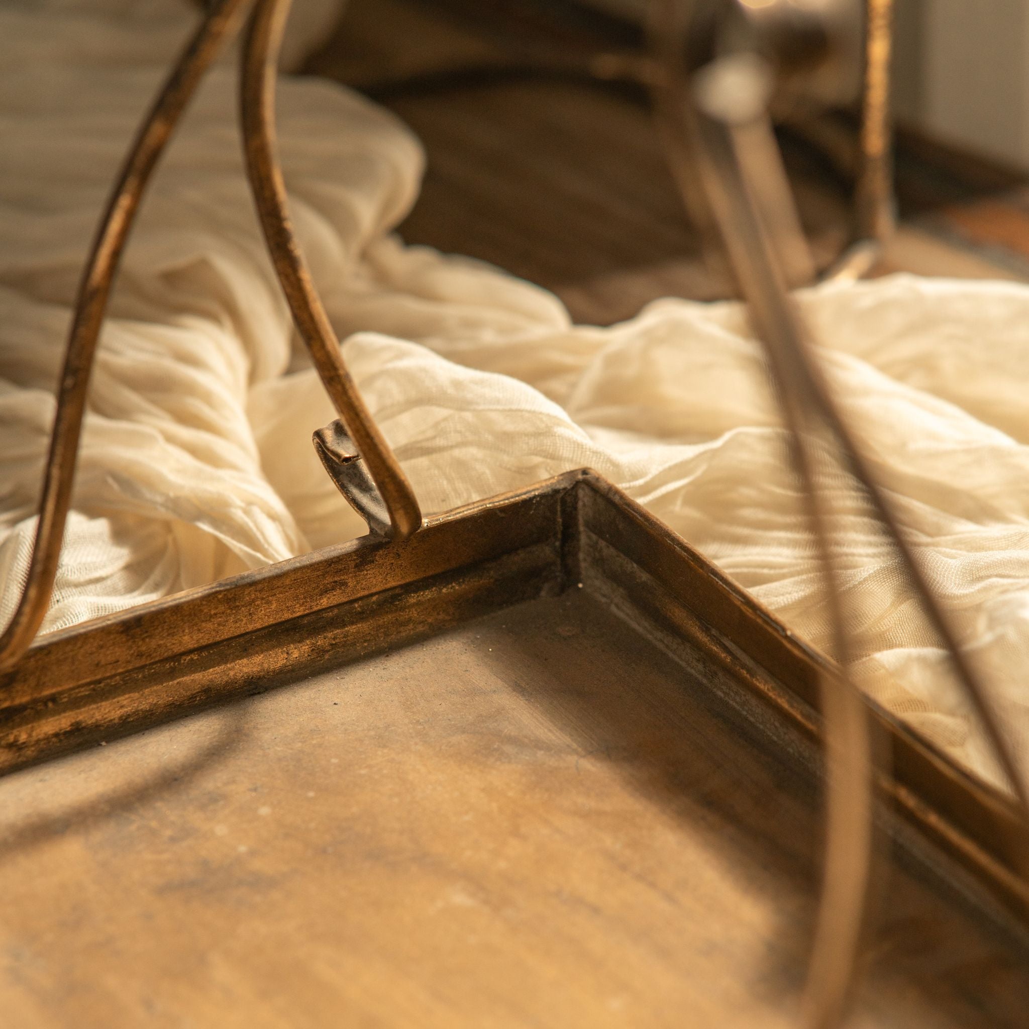 Corner detail of the Risette tray showing the gilded frame, scrolled handle base, and foot.