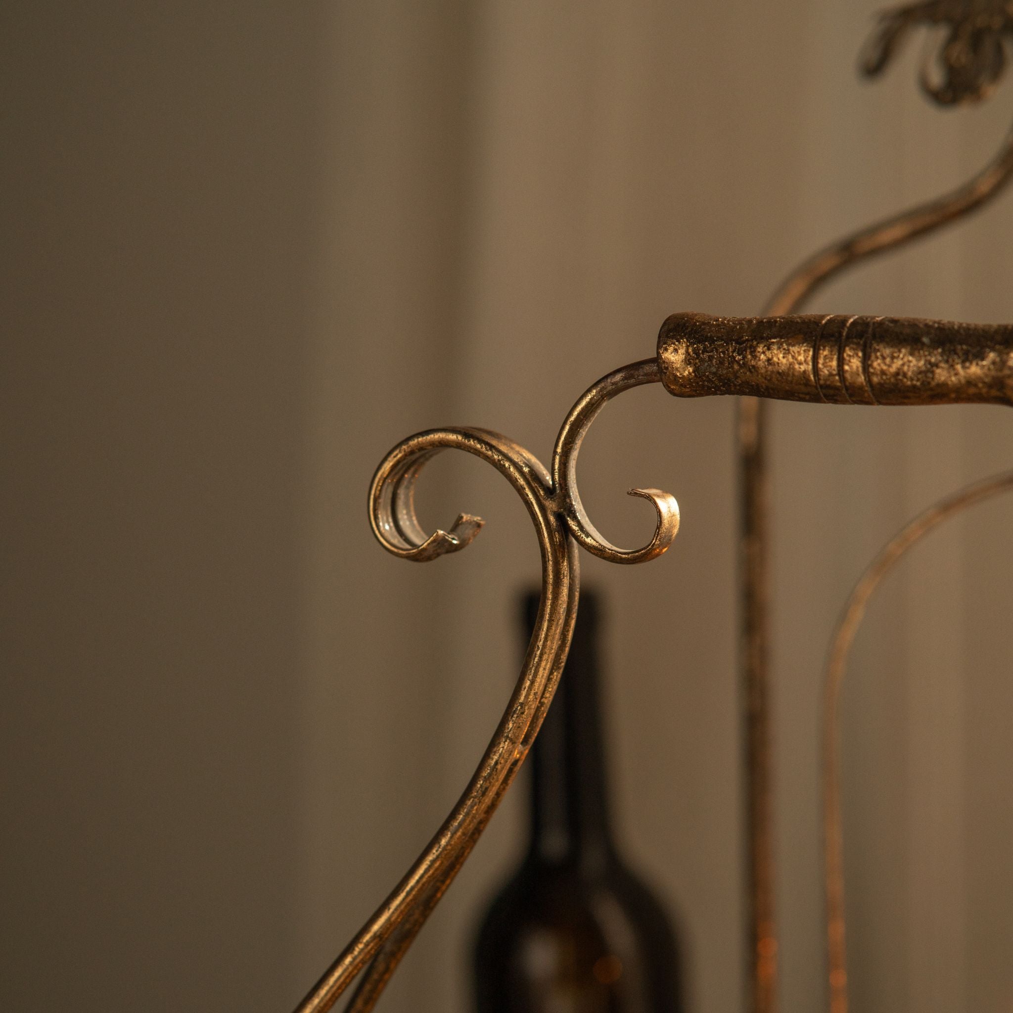 Close-up of the scrolled metal carry handle and turned grip on the Risette tray.