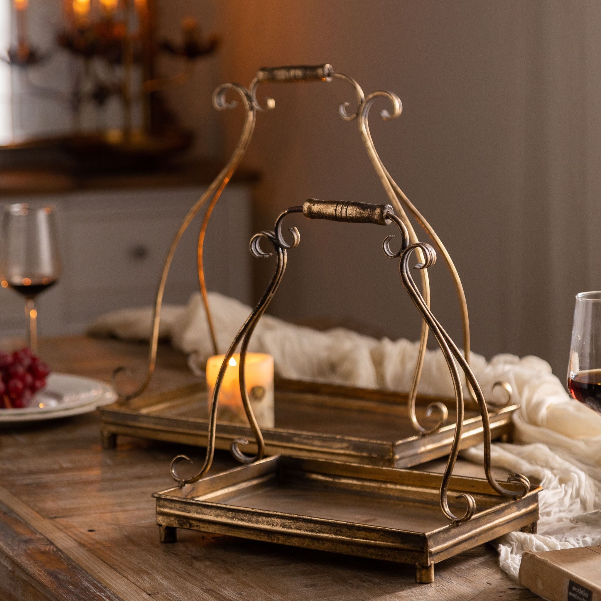 Risette handled trays styled on a dressed table with candlelight.