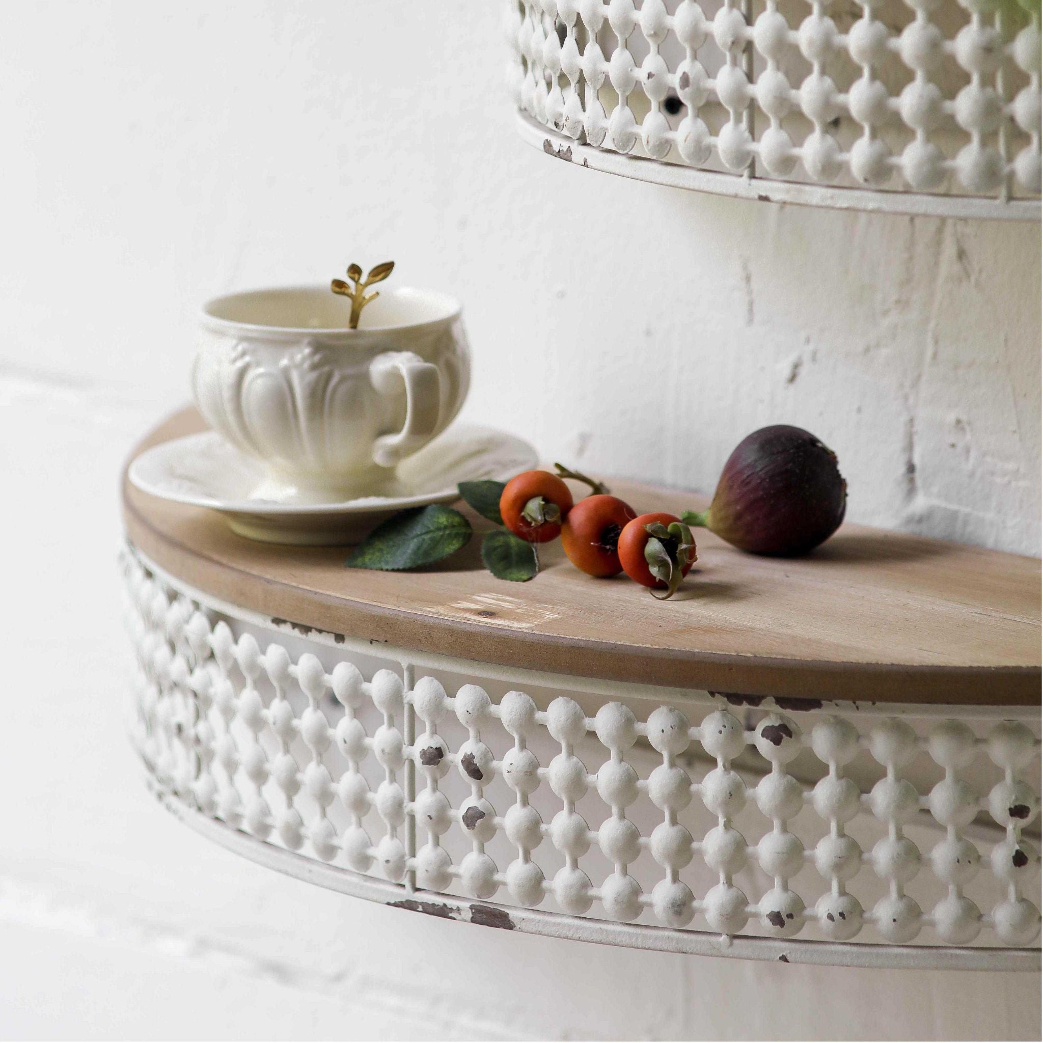 Rolande half moon wall shelf at an angle, showing the demilune timber top and the ball lattice metal gallery.