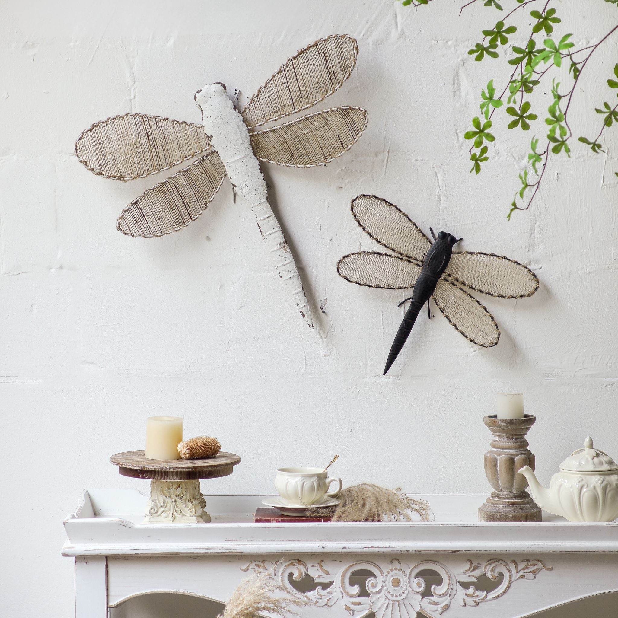Two dragonfly wall pieces styled together, the dark Romy with the larger white dragonfly sold separately