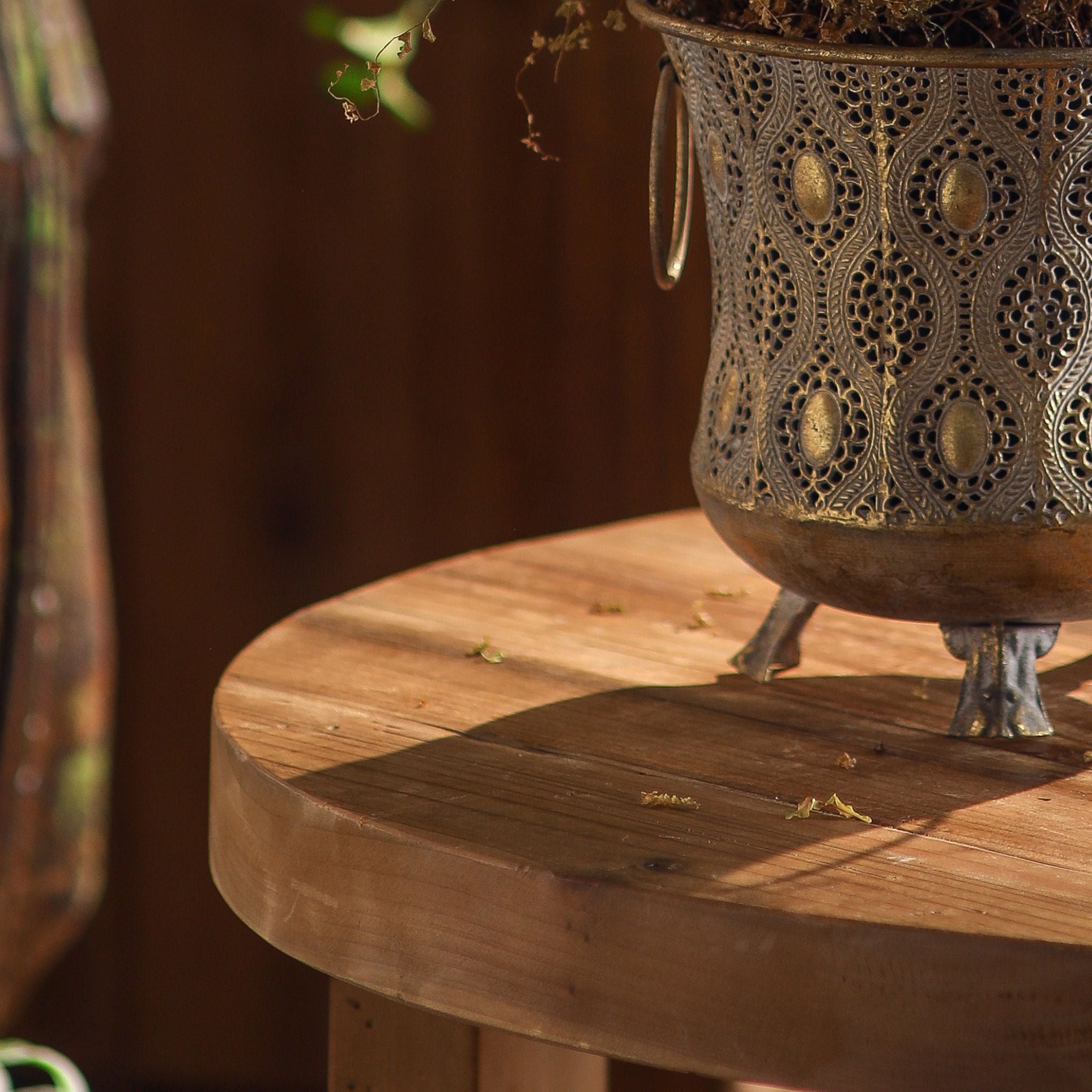 Close-up of the pierced filigree pattern, ring handle, and splayed foot on the Seychelle planter.