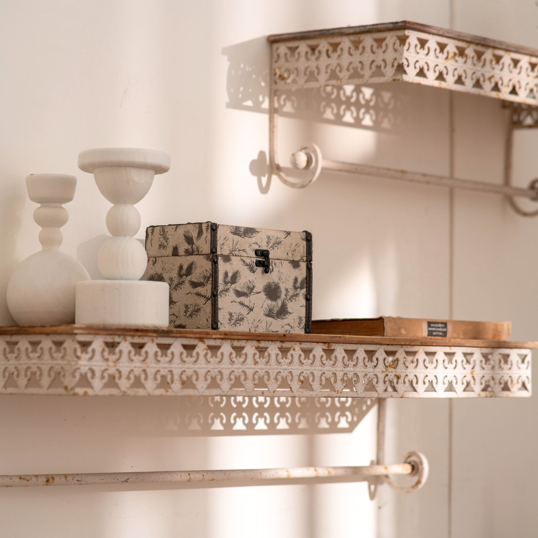 Simone wall shelves styled with pale objects and a fabric box, fretwork edge visible