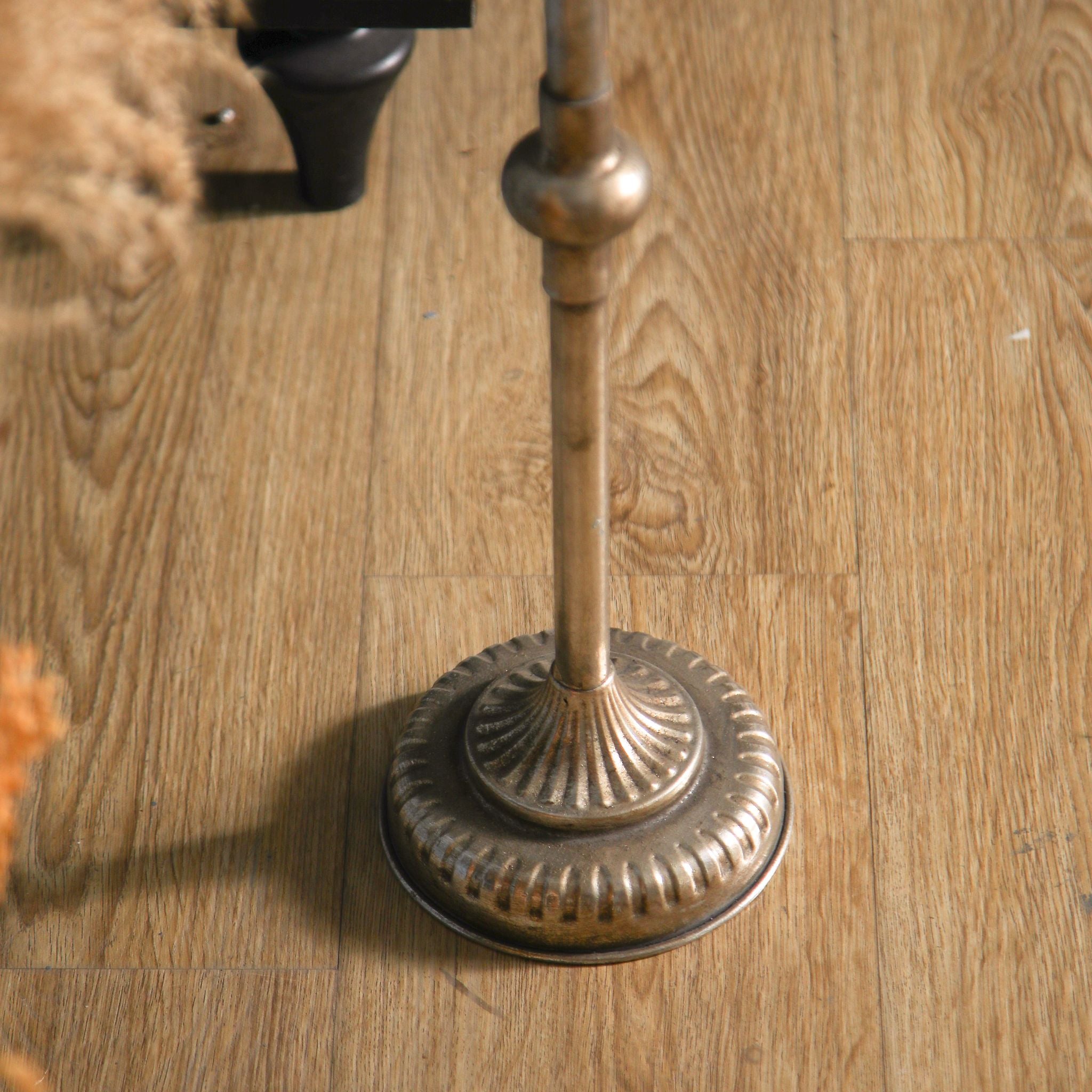 Close detail of the Sylvestre candle holder's fluted antique gold base.