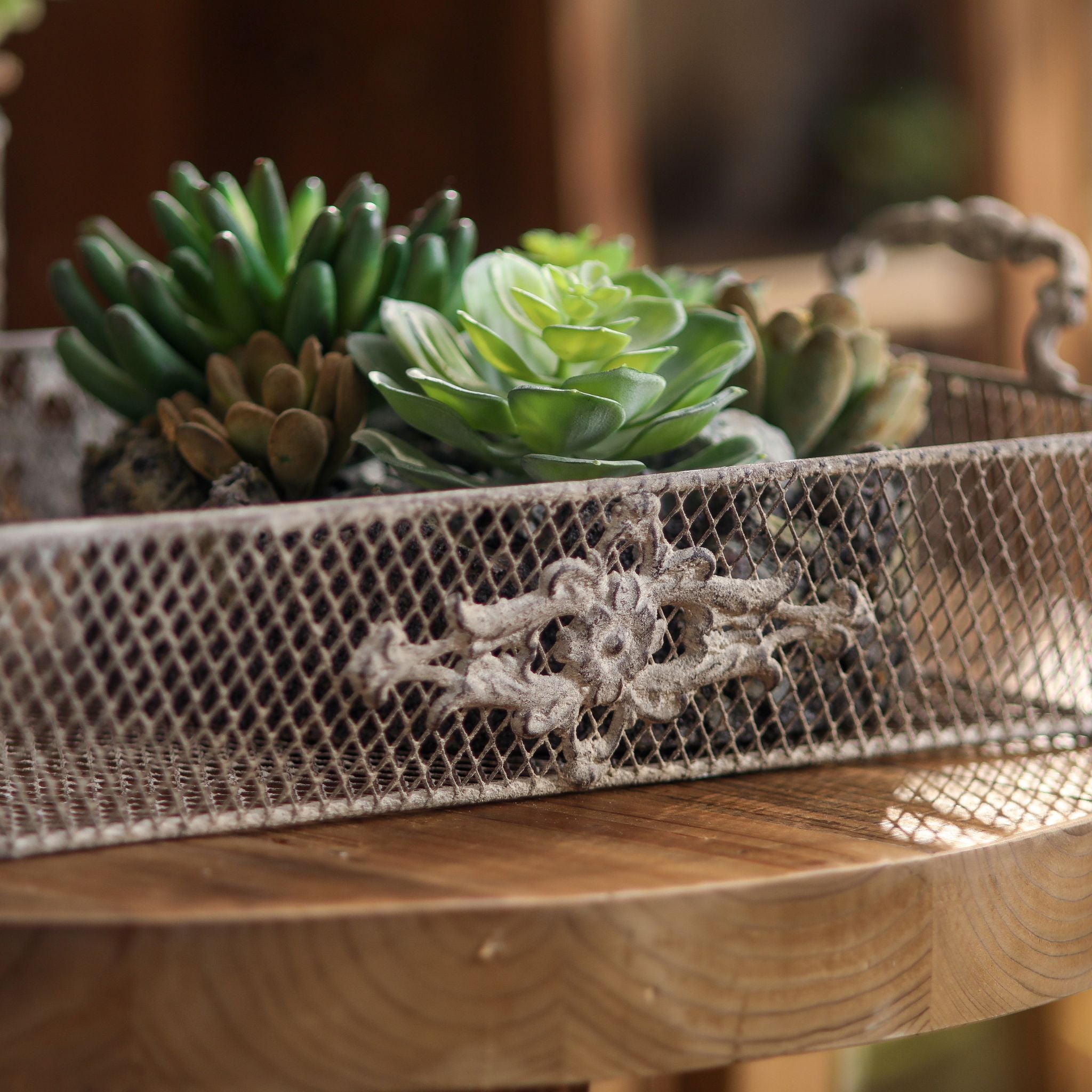 Close view of the floral relief panel and wire mesh on the Sylvie tray