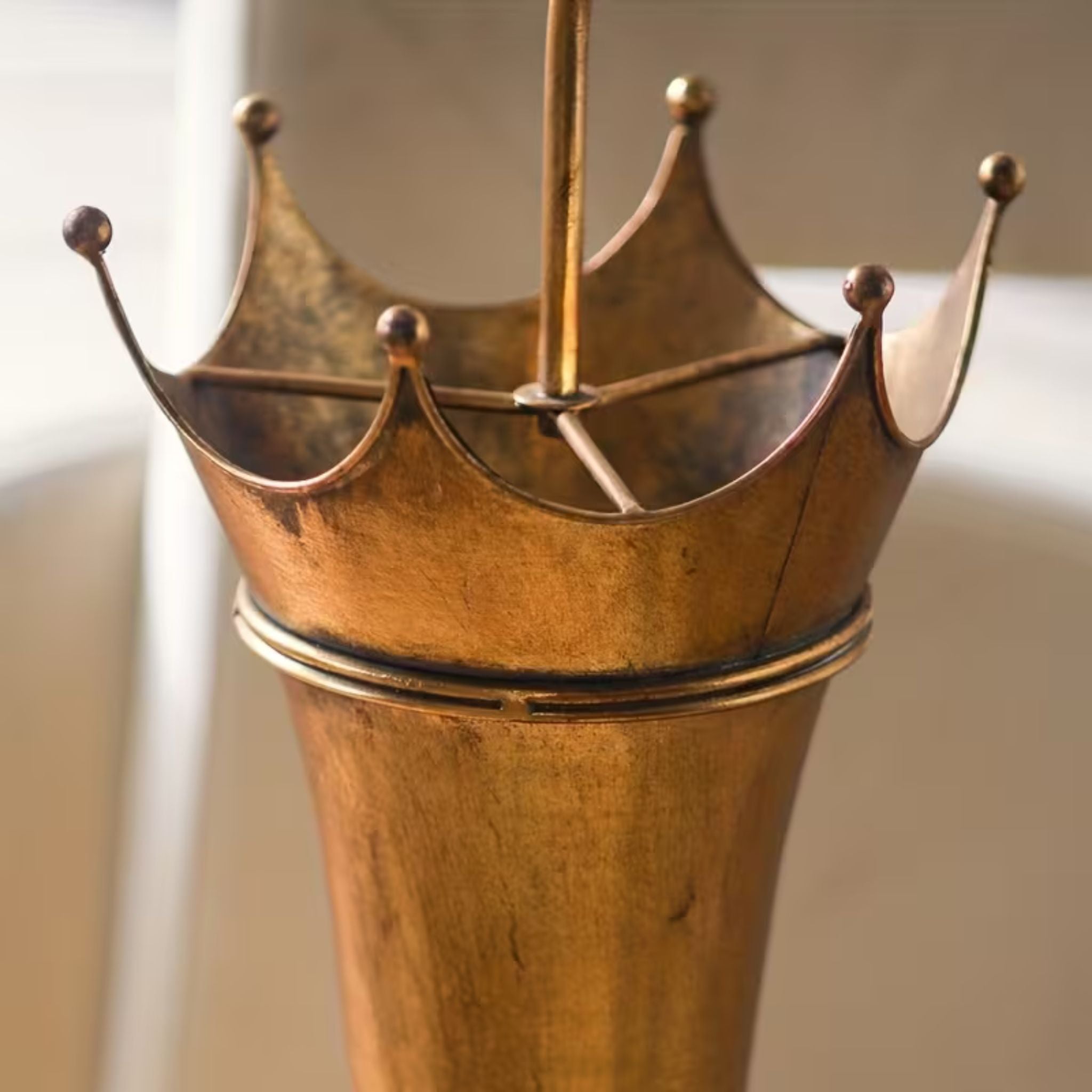 Close-up of the crown peaks and centre post on the Theo Victor umbrella stand.