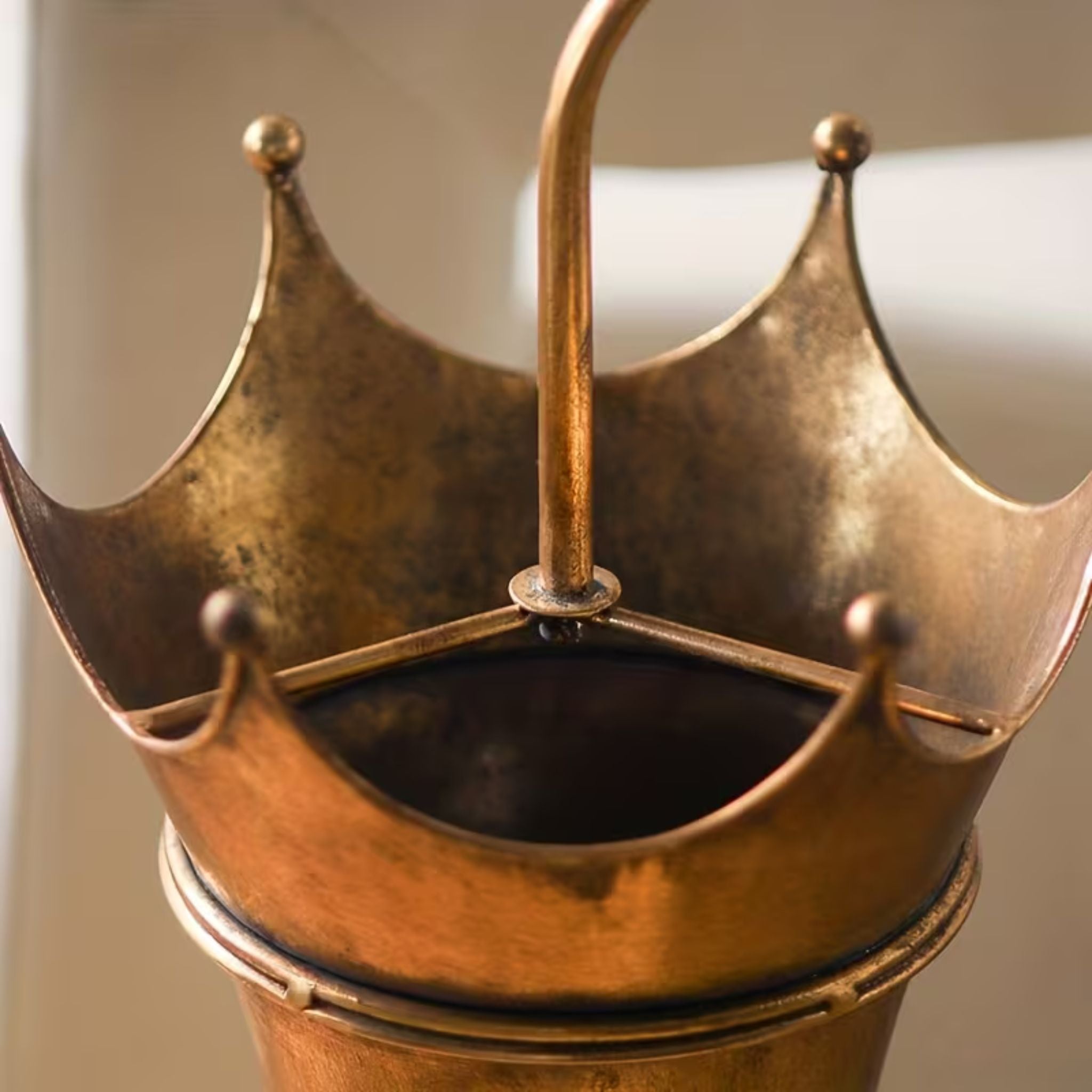 Crown top and curled crook handle of the Theo Victor umbrella stand.
