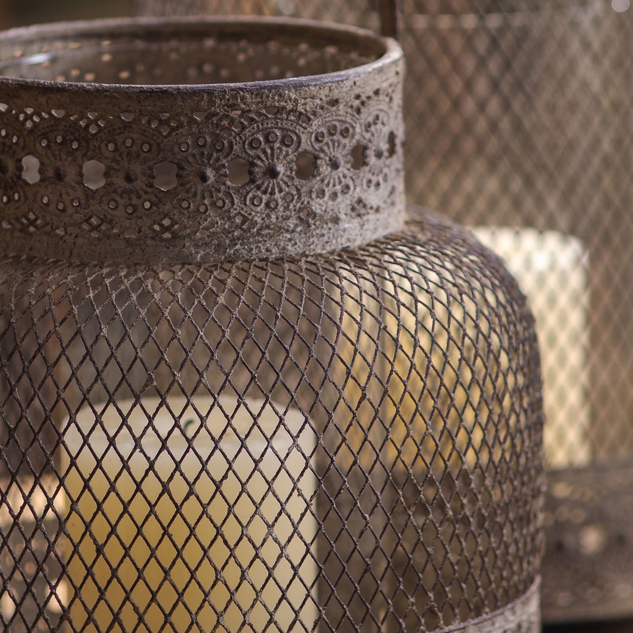 Close-up of fine diamond mesh and pierced lace border on the metal lantern
