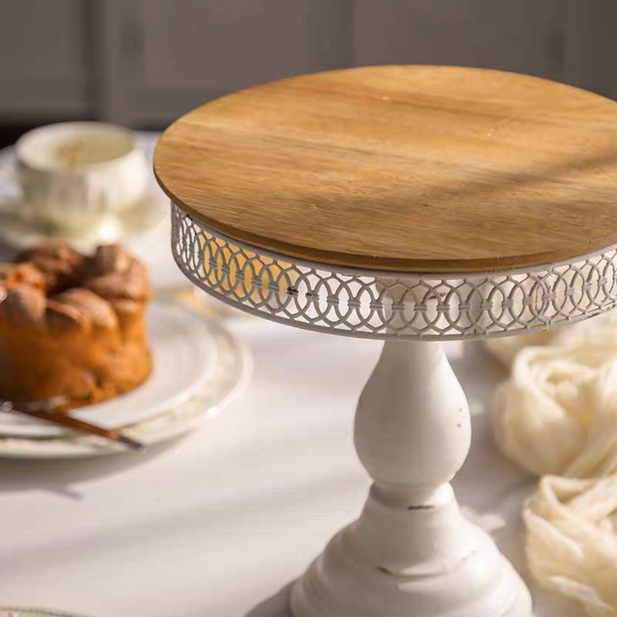 Close-up of the timber top and pierced linked-circle gallery on the Violette cake stand.