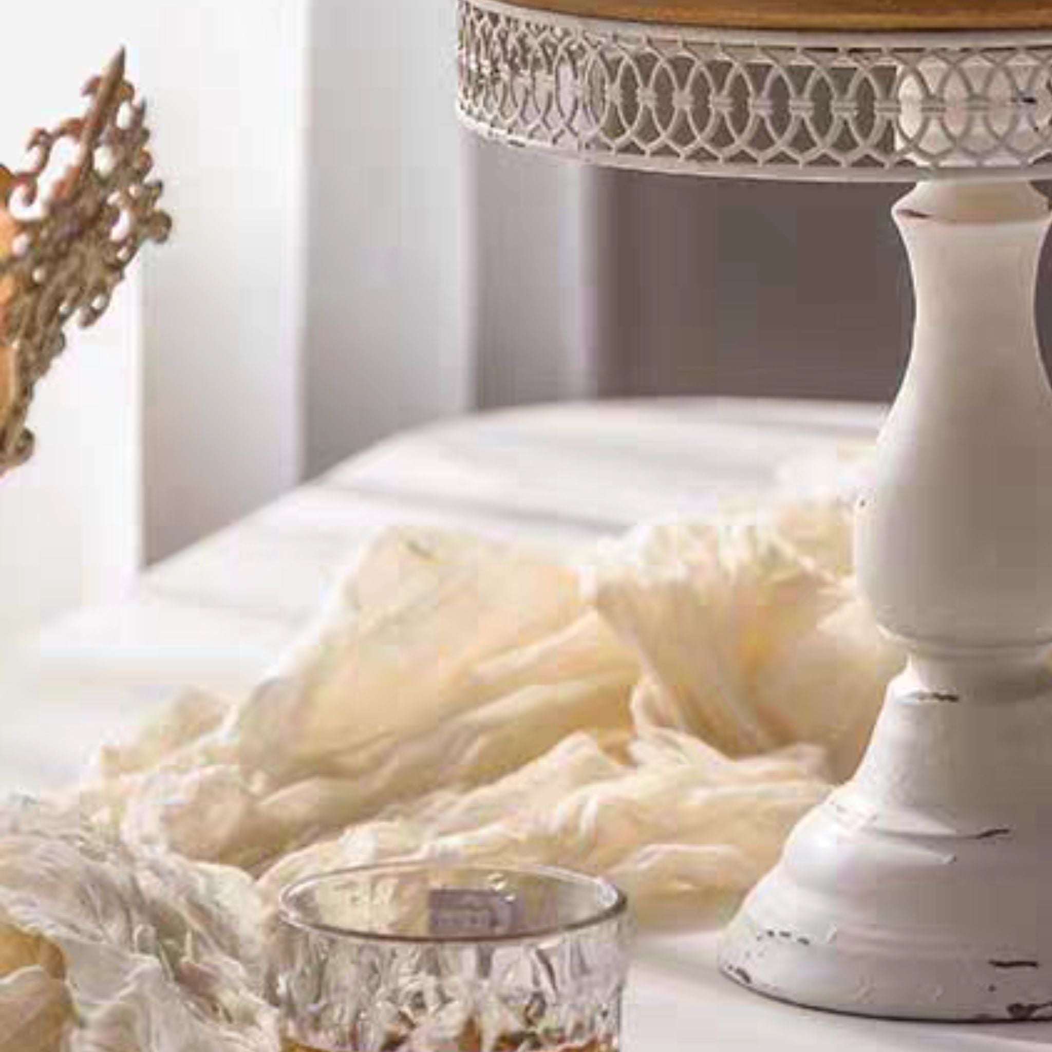 Turned pedestal and flared foot of the Violette cake stand in distressed antique white.