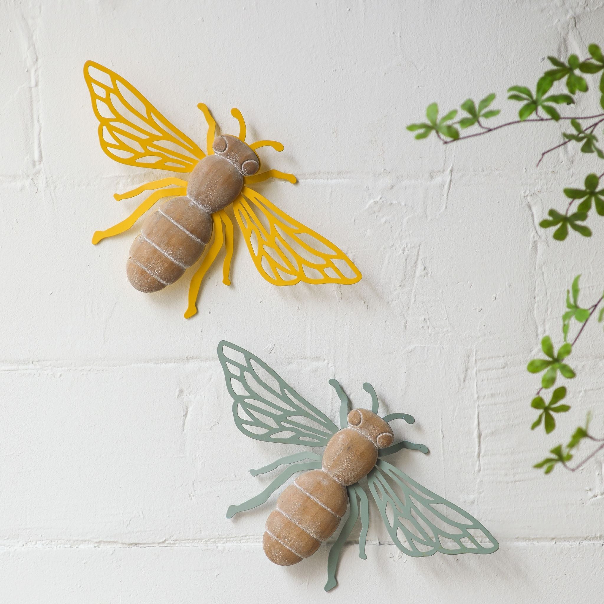 Willy sage green bee styled in a full room context above a shelf with cream candles, pampas grass, and antique pillar holders