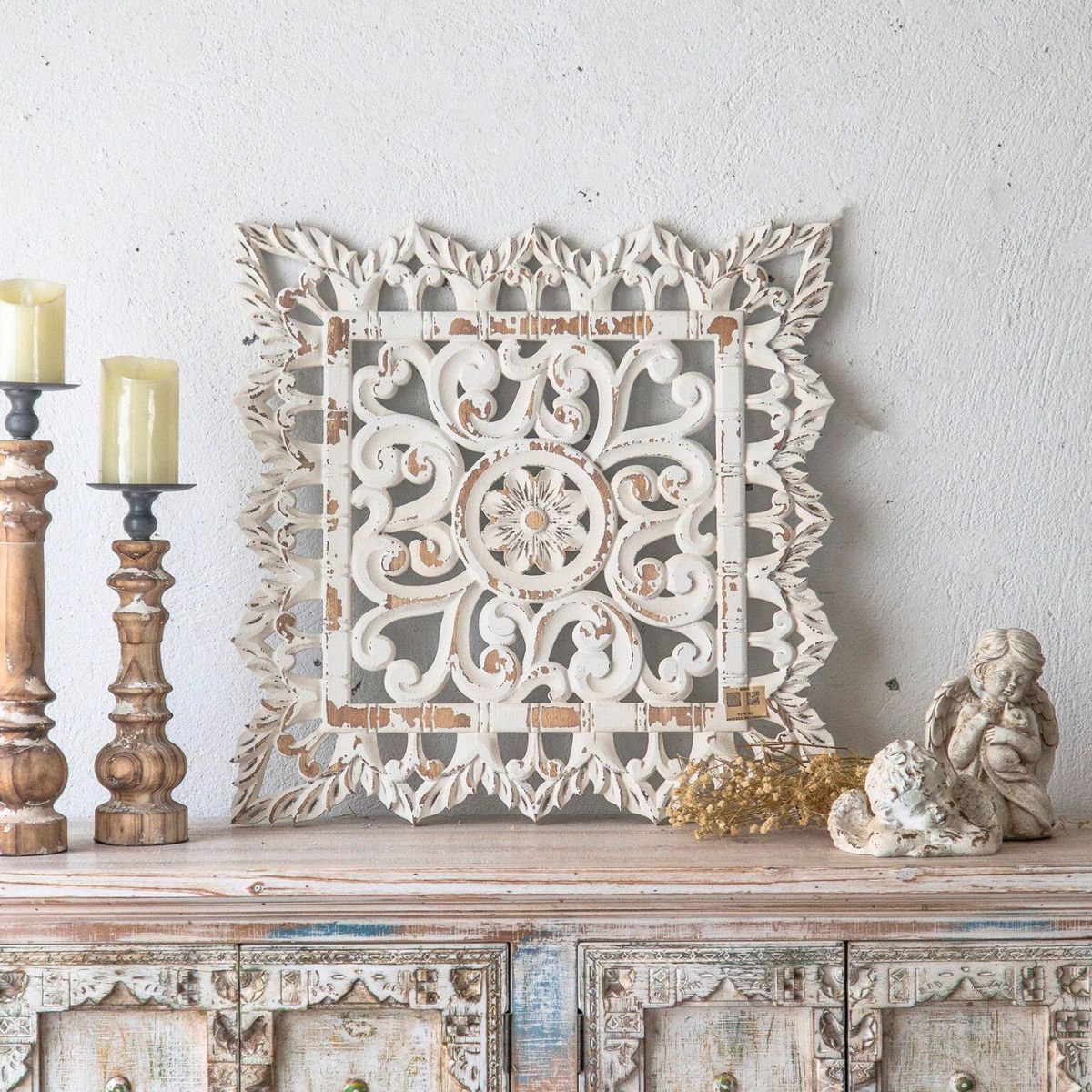 Handcrafted French Provincial carved wooden wall art in distressed white finish, styled with antique candlesticks and cherub figurine on rustic timber console — Château Living Wall Art Sale collection