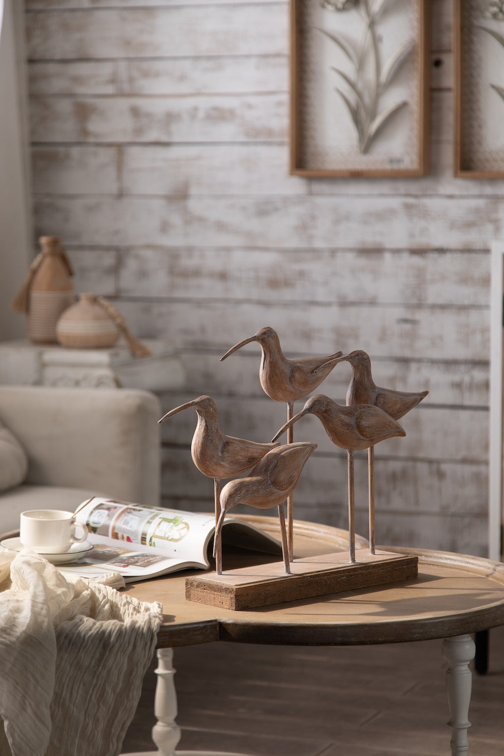 Home accents with decorative bird sculptures, candle holders, and tray in a cozy rustic living room – Chateau Living décor