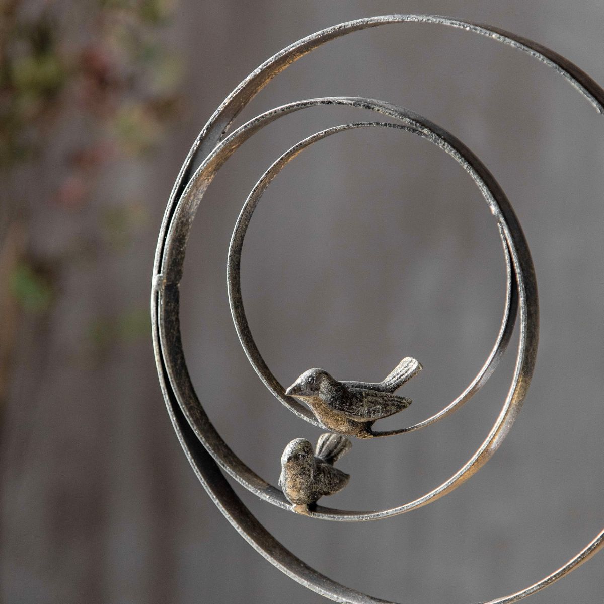 Close-up of aged metal birds and rings on the Tristan sculpture by Château Living