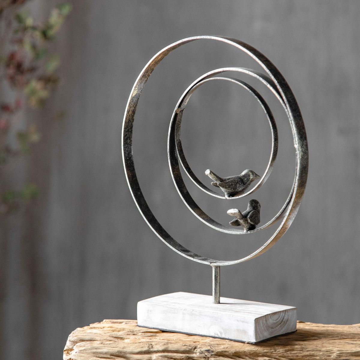 Back view of Tristan bird sculpture showing weathered black metal finish and timber grain