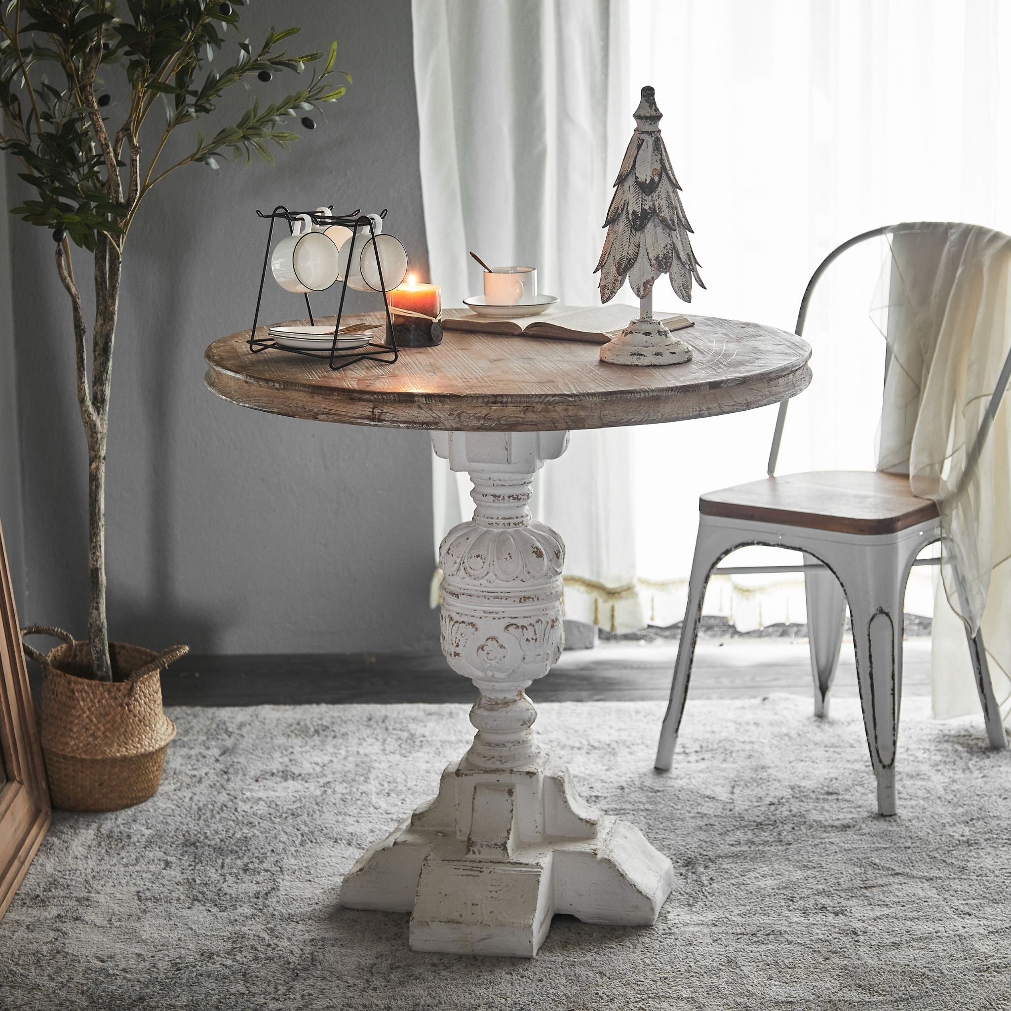 Close view of the Bellagio table carved pedestal base in distressed white