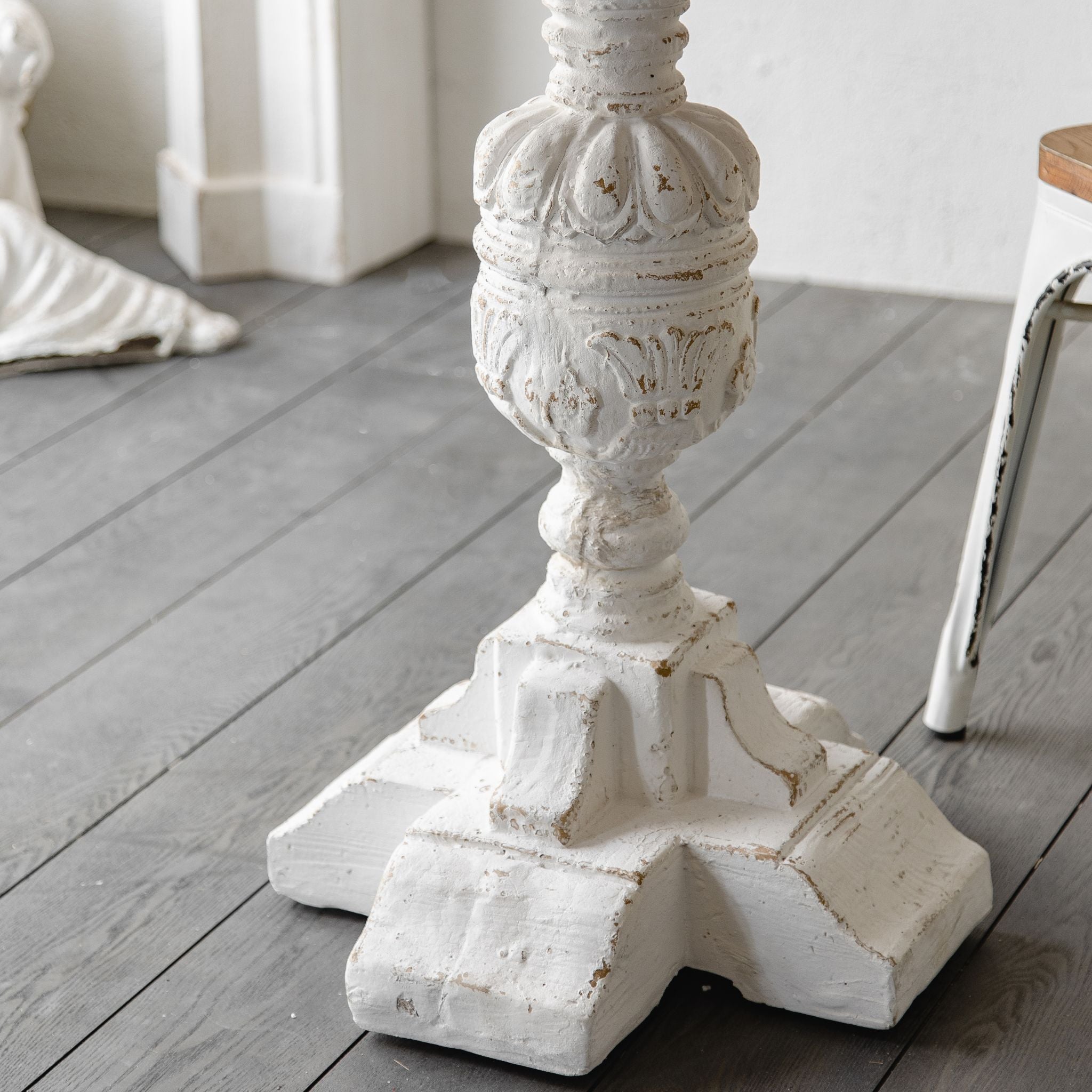Bellagio round pedestal table by a window styled for morning coffee