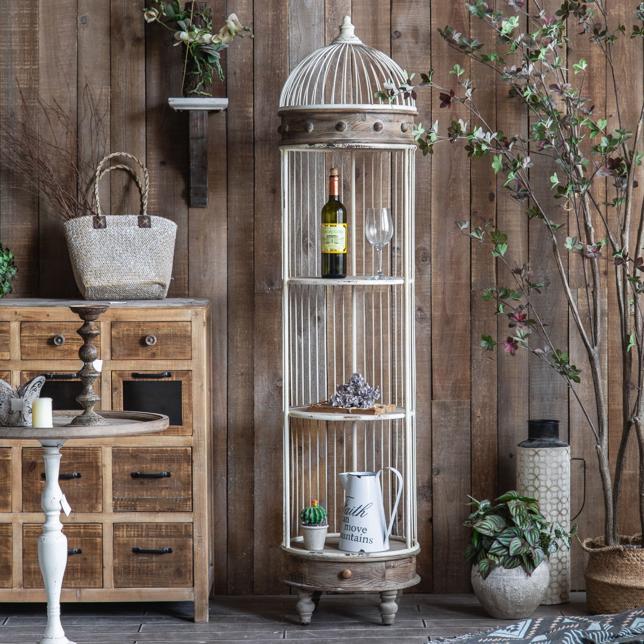 Brindisi birdcage display shelf in cream iron with timber band, full view in a rustic room