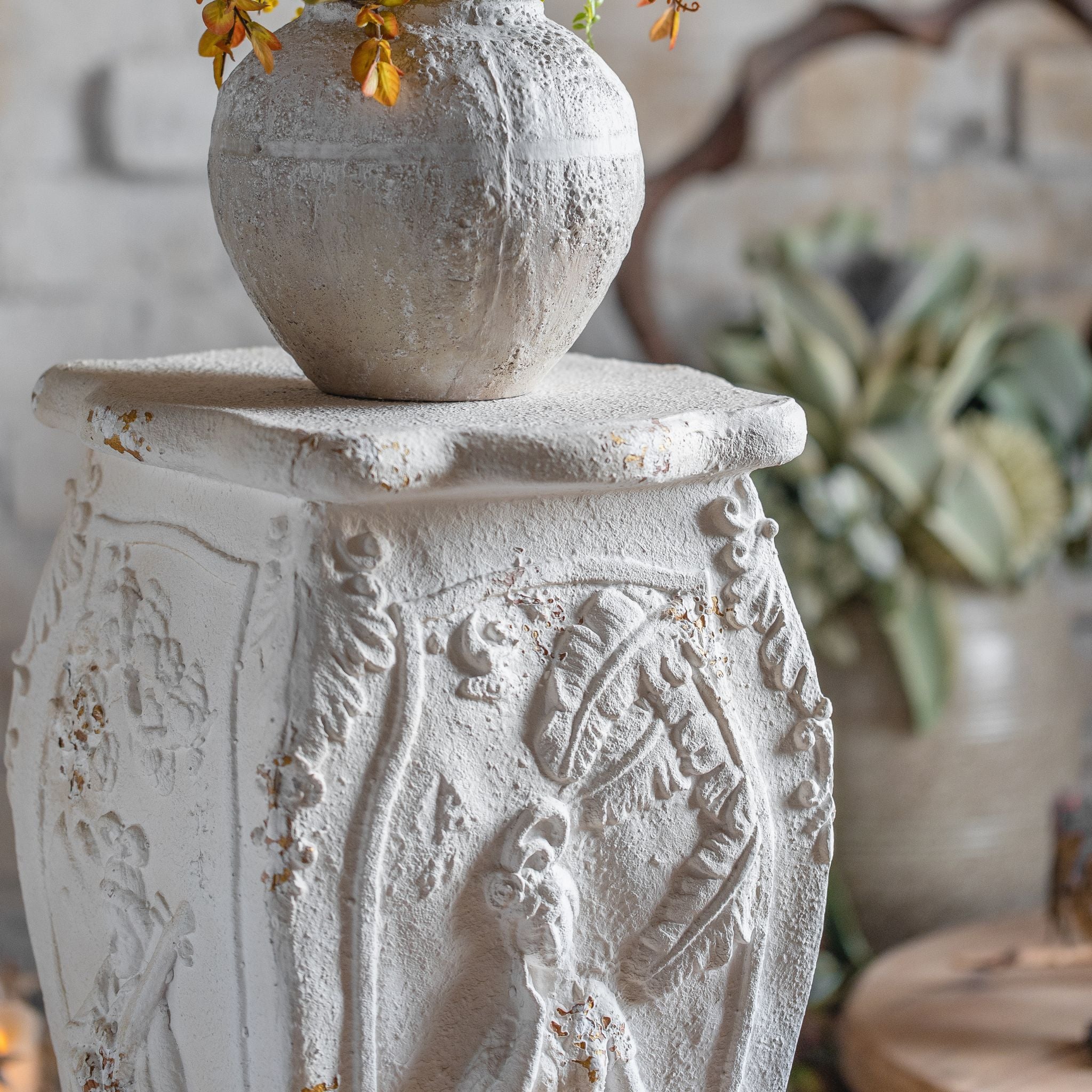 Cadiz pedestal styled with an urn vase on top