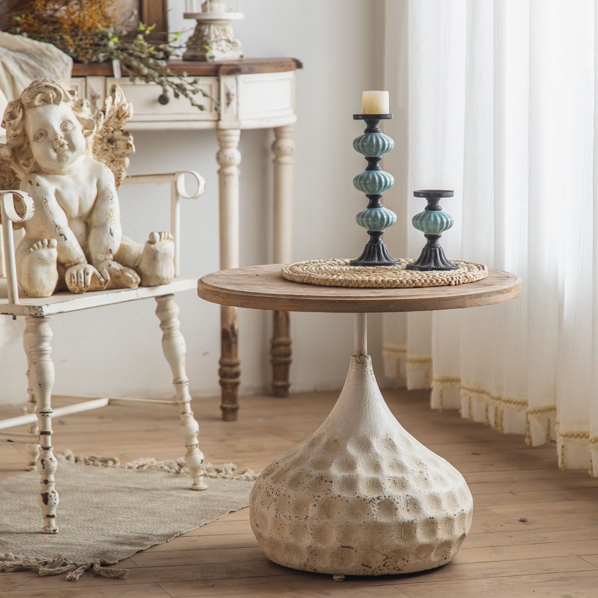 Tullia round side table with fir top and hammered bronze pedestal in a living room