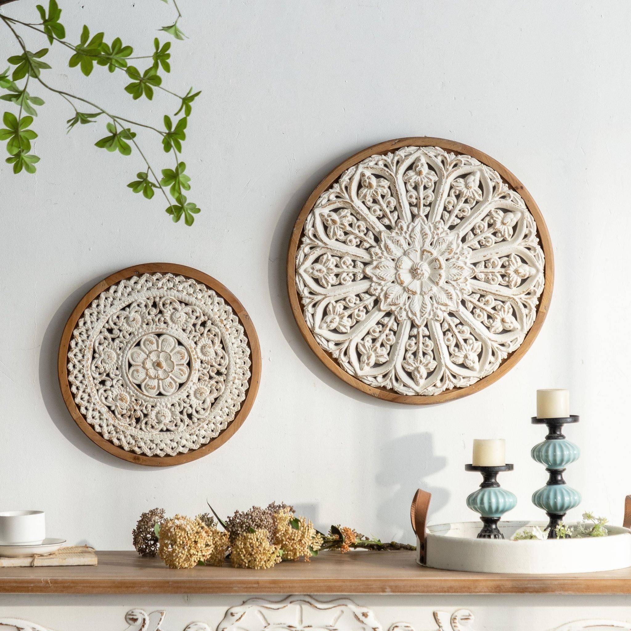 Zola round carved panel styled on a wall with her larger match Zita