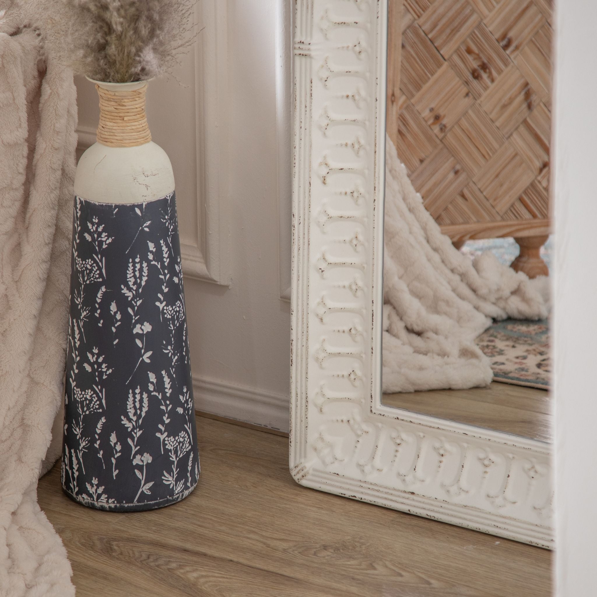 Close view of the embossed pattern and arch on the Theron mirror frame