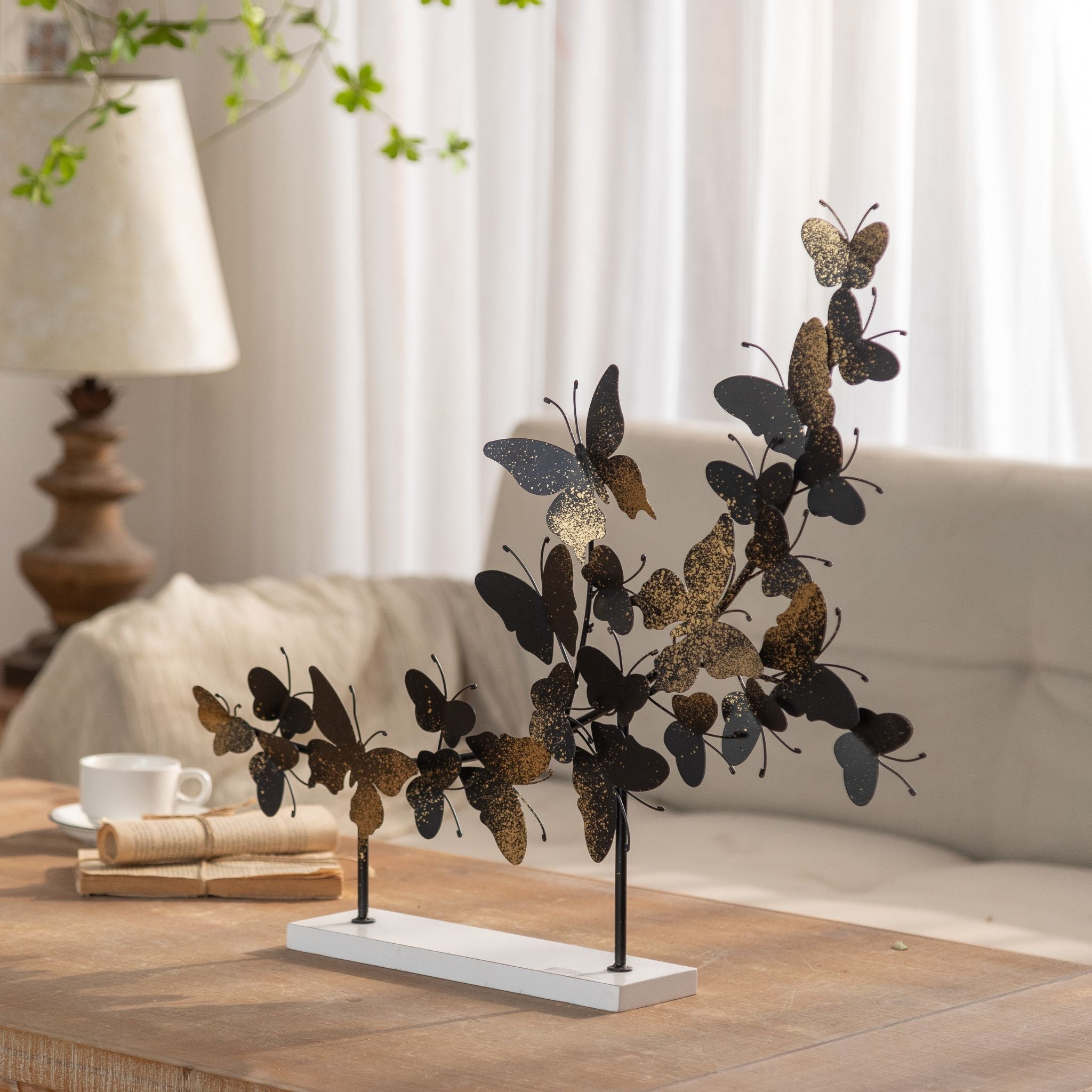 Tessa butterfly sculpture styled on a coffee table in a light living room