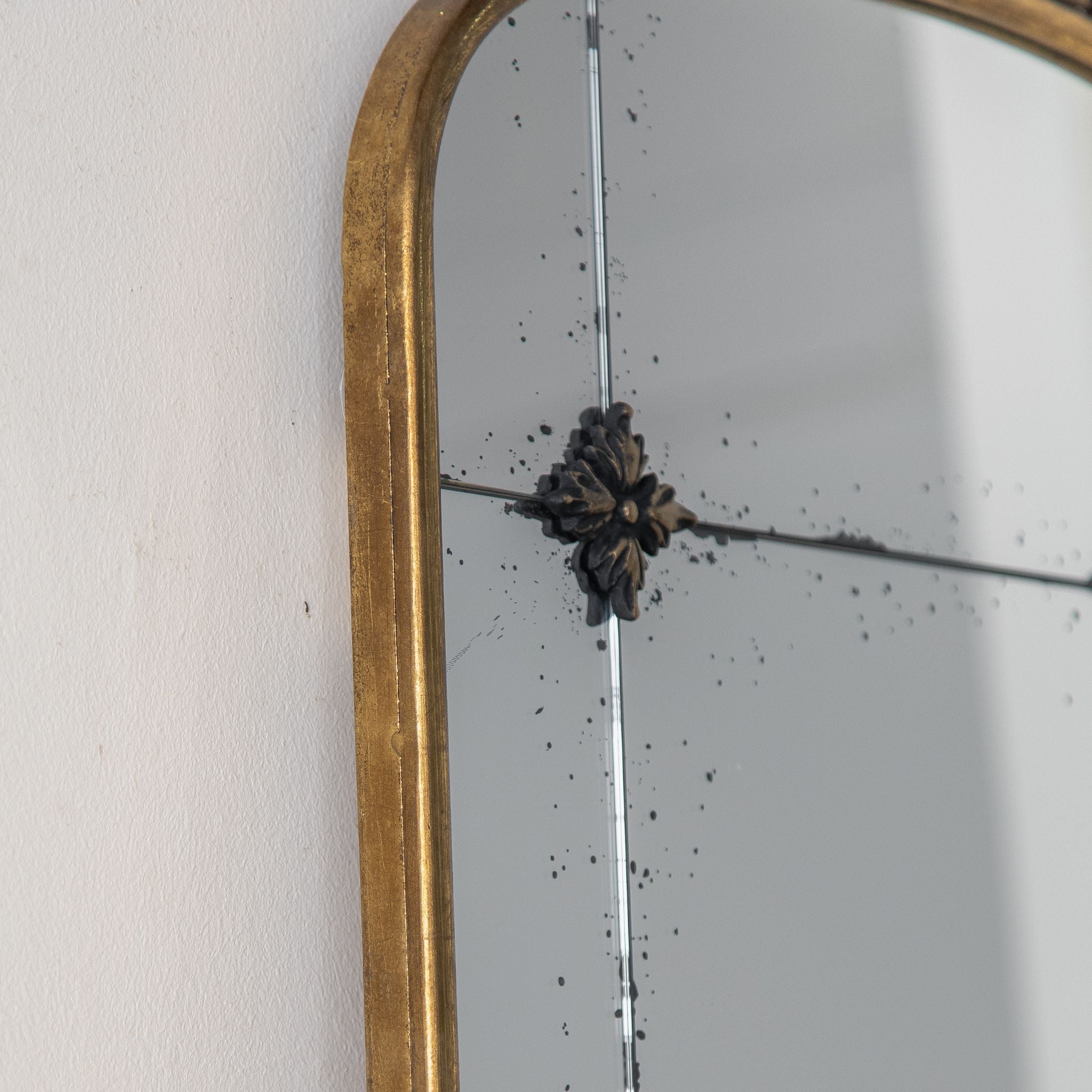 Thea arched mirror metal rosette and antiqued speckled glass detail