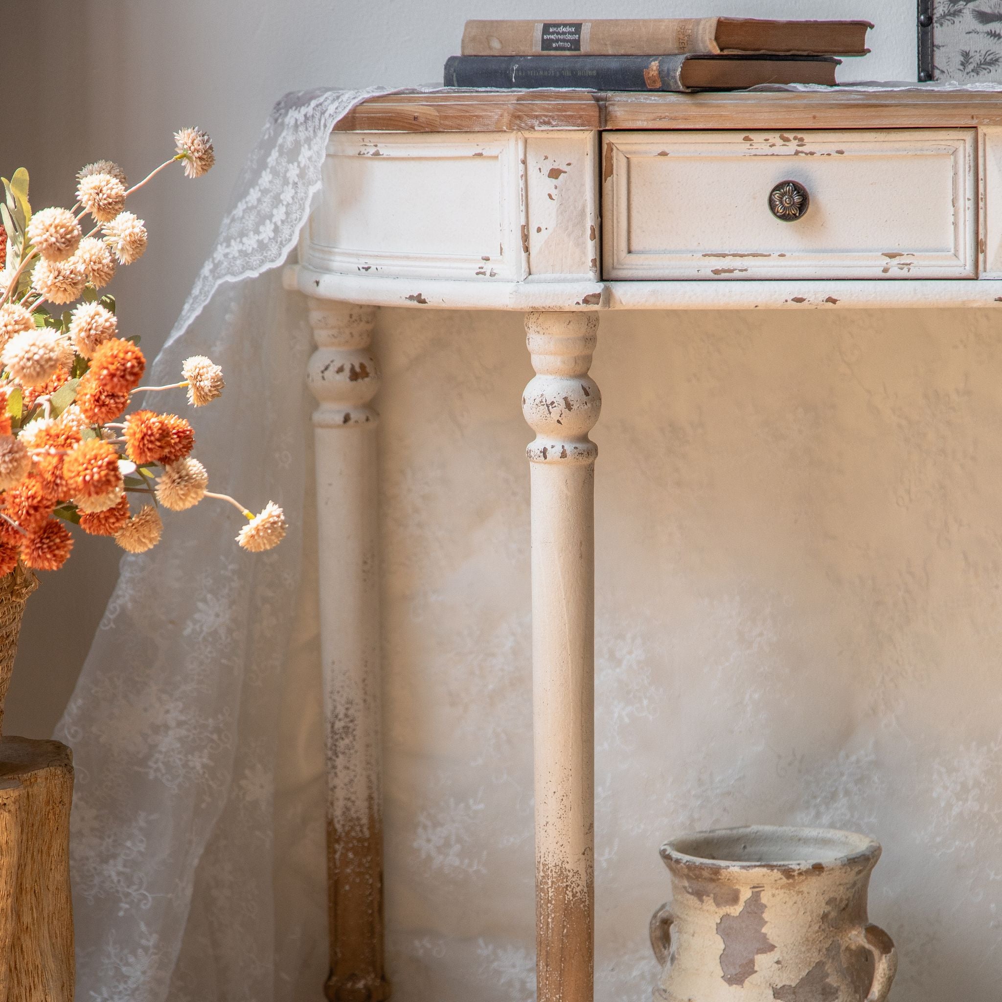 Detail of the Talia console timber top edge and drawer fronts with brass rosette knobs