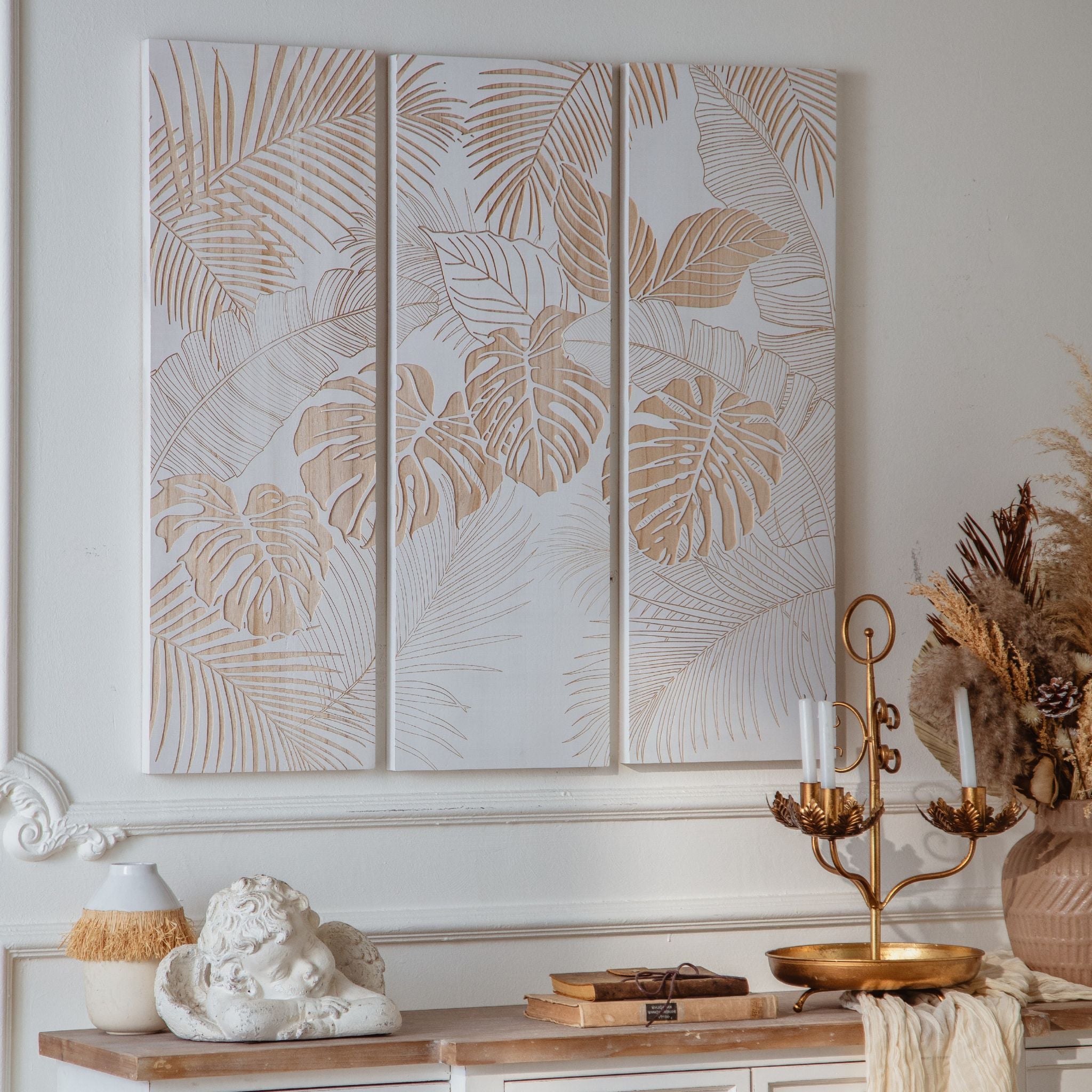 Close view of the carved monstera and palm leaf detail on the Sole wall panels