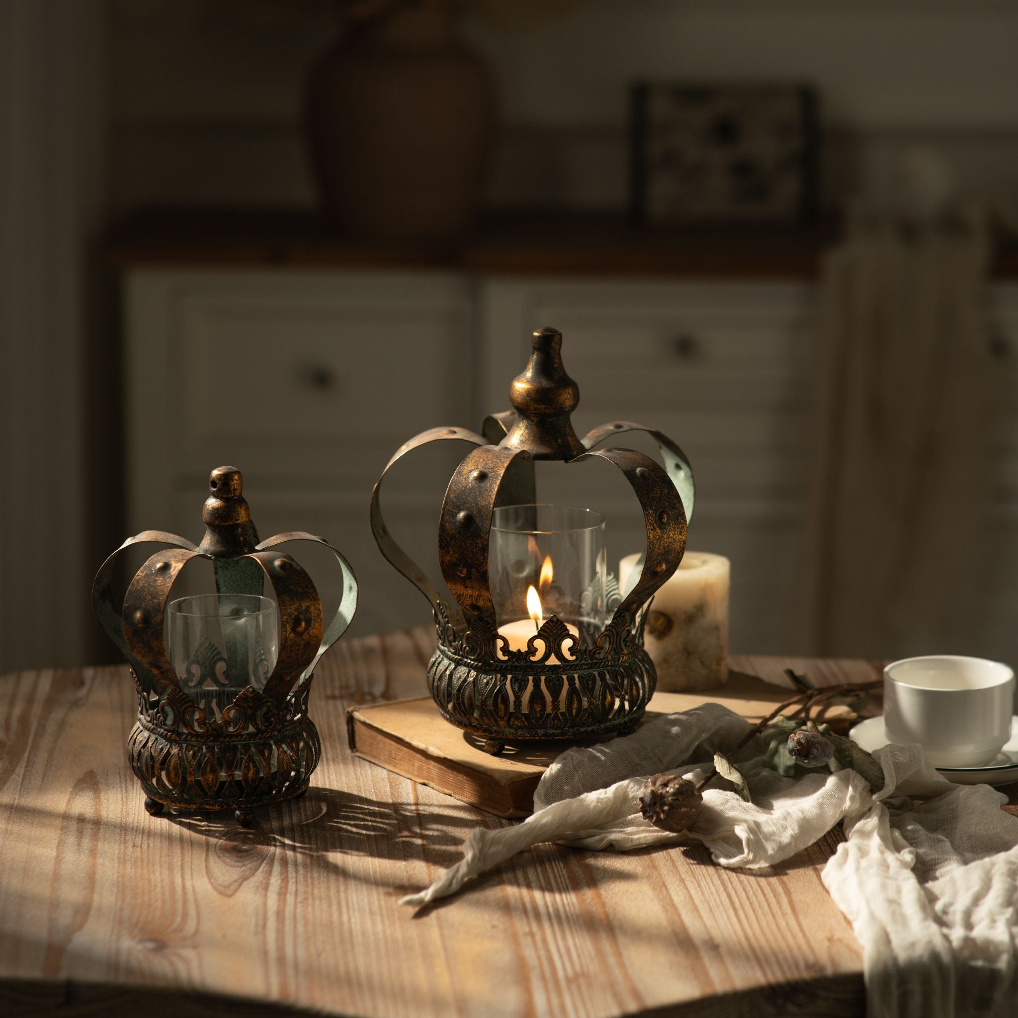 Rhodes crown candle holders large and small styled on a timber table with books